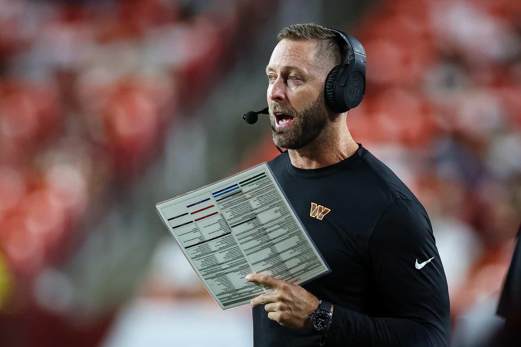 LANDOVER, MD - AUGUST 25: Offensive coordinator Kliff Kingsbury of the Washington Commanders calls a play against the New England Patriots during the fourth quarter of the preseason game at Commanders Field on August 25, 2024 in Landover, Maryland. (Photo by Scott Taetsch/Getty Images)