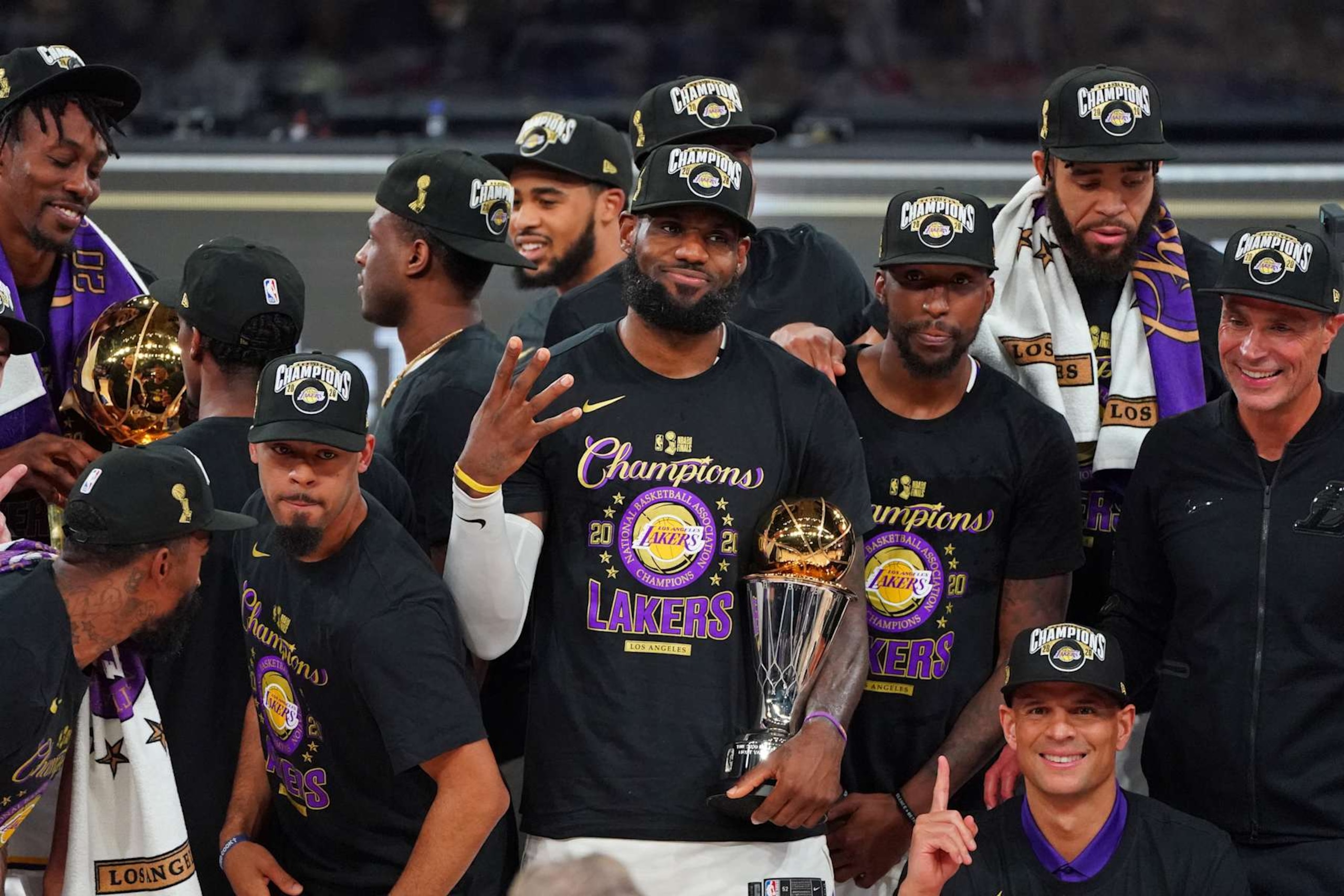ORLANDO, FL - OCTOBER 11: LeBron James #23 of the Los Angeles Lakers celebrates with the Bill Russell Finals MVP Trophy on court after winning Game Six of the NBA Finals against the Miami Heat on October 11, 2020 in Orlando, Florida at AdventHealth Arena. NOTE TO USER: User expressly acknowledges and agrees that, by downloading and/or using this Photograph, user is consenting to the terms and conditions of the Getty Images License Agreement. Mandatory Copyright Notice: Copyright 2020 NBAE (Photo by Jesse D. Garrabrant/NBAE via Getty Images)