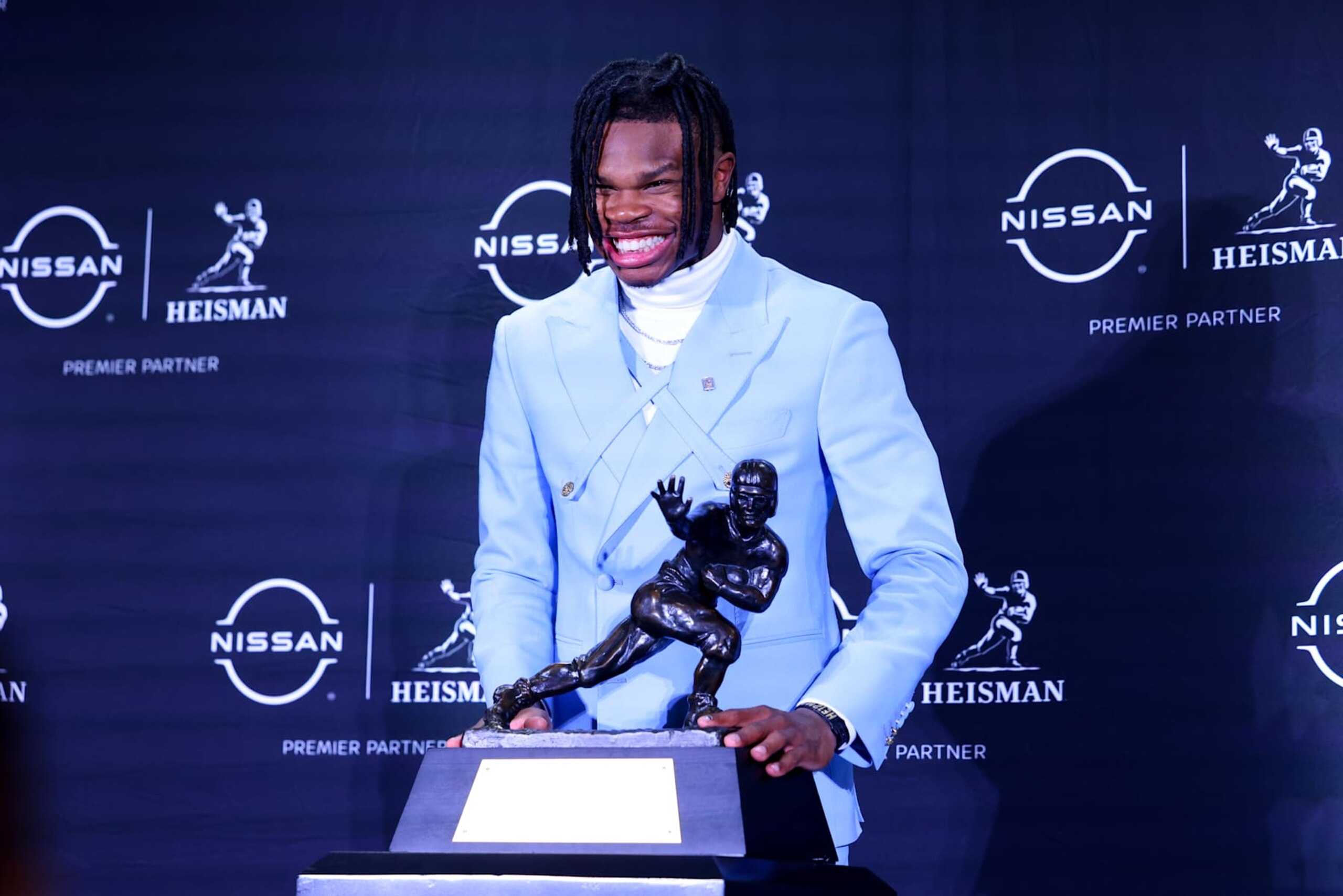 NEW YORK, NY - DECEMBER 14:  Travis Hunter University of Colorado cornerback/wide receiver poses with the Trophy during the Heisman Trophy press conference at the Marriott Marquis on December 14, 2024 in New York, New York. (Photo by Rich Graessle/Icon Sportswire via Getty Images)