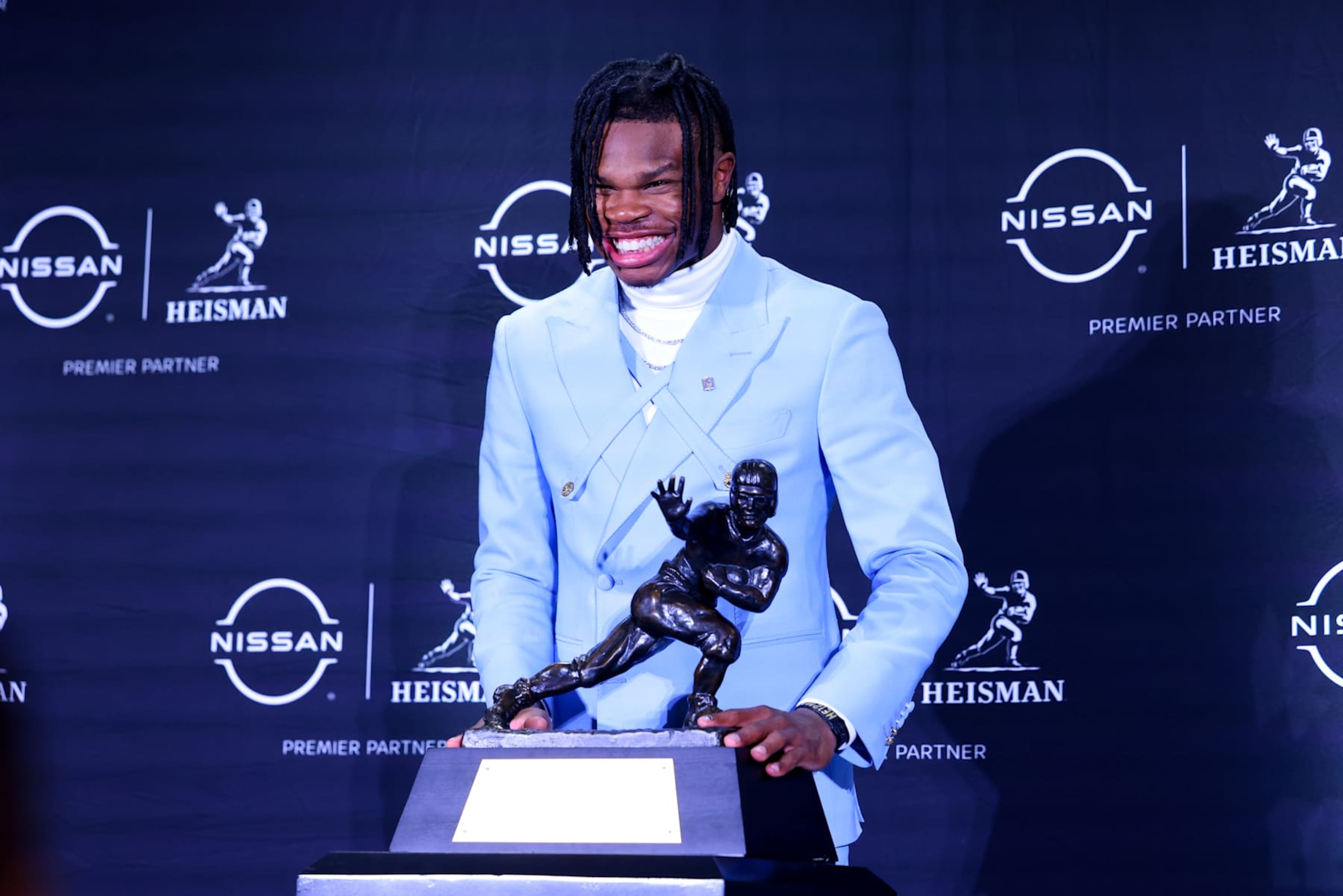 NEW YORK, NY - DECEMBER 14:  Travis Hunter University of Colorado cornerback/wide receiver poses with the Trophy during the Heisman Trophy press conference at the Marriott Marquis on December 14, 2024 in New York, New York. (Photo by Rich Graessle/Icon Sportswire via Getty Images)
