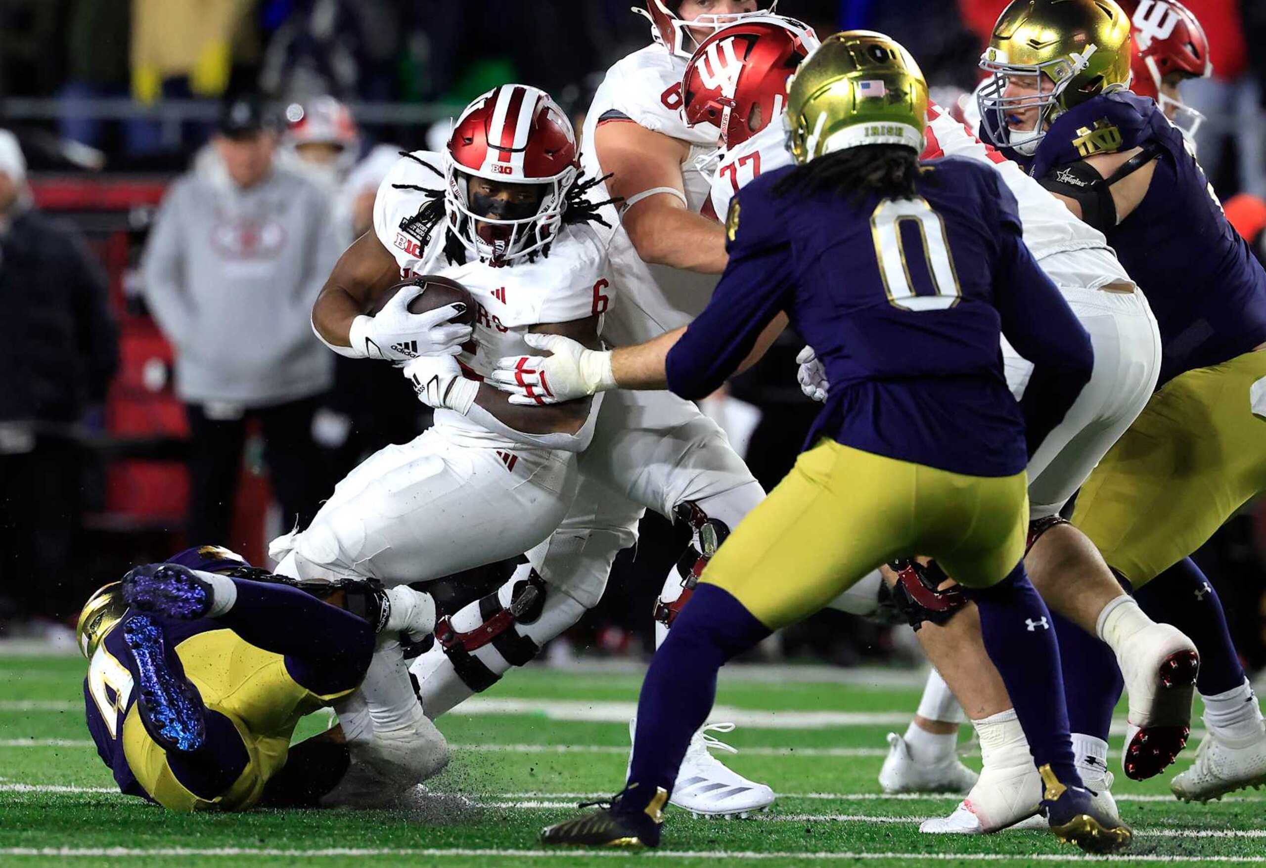 SOUTH BEND, INDIANA - DECEMBER 20: Justice Ellison #6 of the Indiana Hoosiers runs the ball during the second quarter against the Notre Dame Fighting Irish in the Playoff First Round game at Notre Dame Stadium on December 20, 2024 in South Bend, Indiana.  (Photo by Justin Casterline/Getty Images)