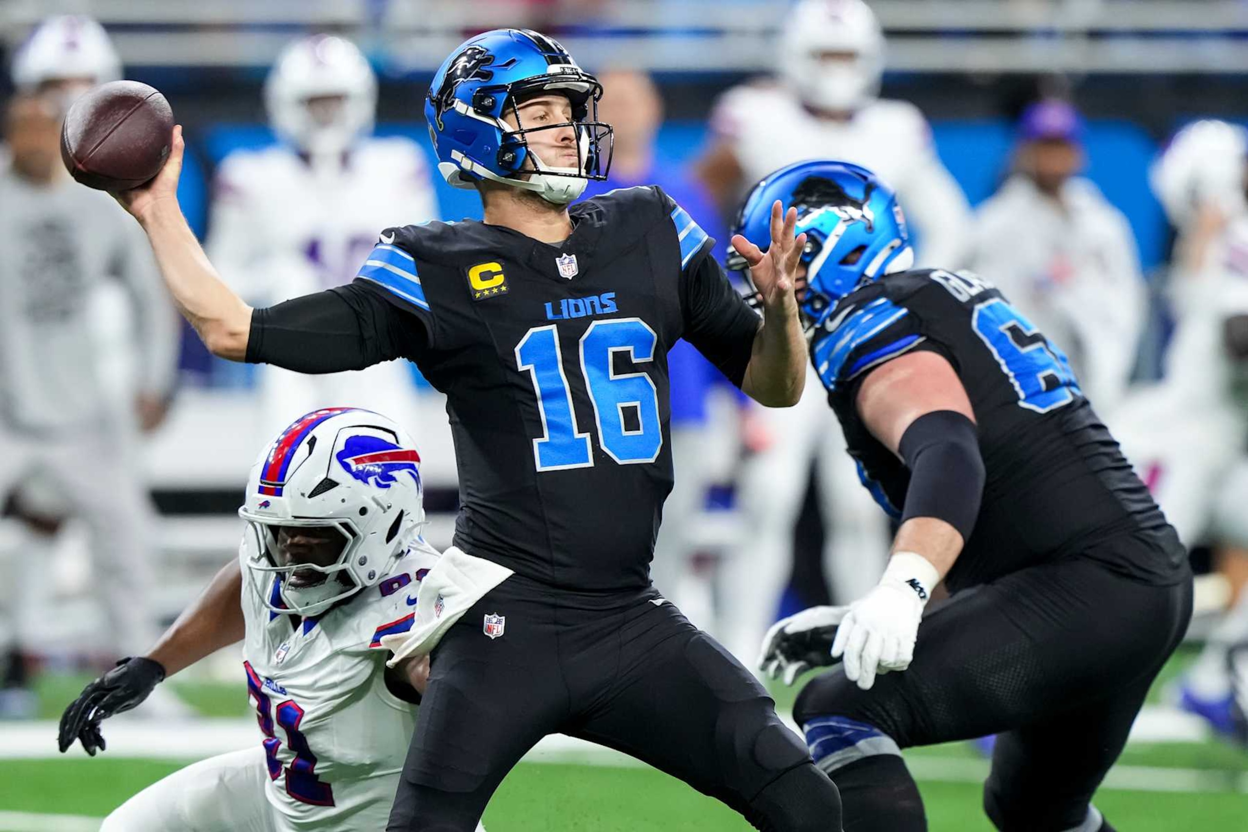 DETROIT, MICHIGAN - DECEMBER 15: Quarterback Jared Goff #16 of the Detroit Lions throws a pass under pressure during an NFL football game against the Buffalo Bills, at Ford Field on December 15, 2024 in Detroit, Michigan. (Photo by Todd Rosenberg/Getty Images)