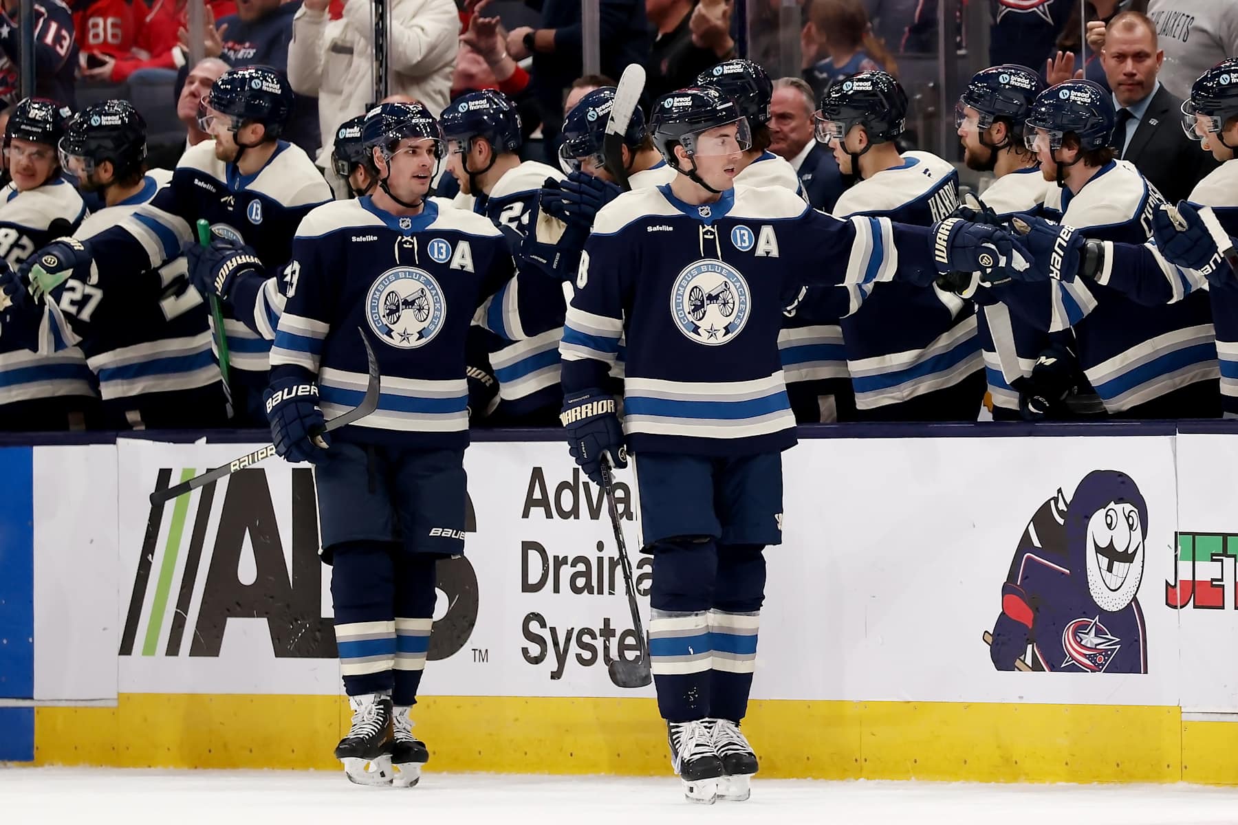 COLUMBUS, OHIO - DECEMBER 19:  Zach Werenski #8 of the Columbus Blue Jackets is congratulated by his teammates after scoring a goal during the second period of the game against the New Jersey Devils at Nationwide Arena on December 19, 2024 in Columbus, Ohio. (Photo by Kirk Irwin/NHLI via Getty Images)