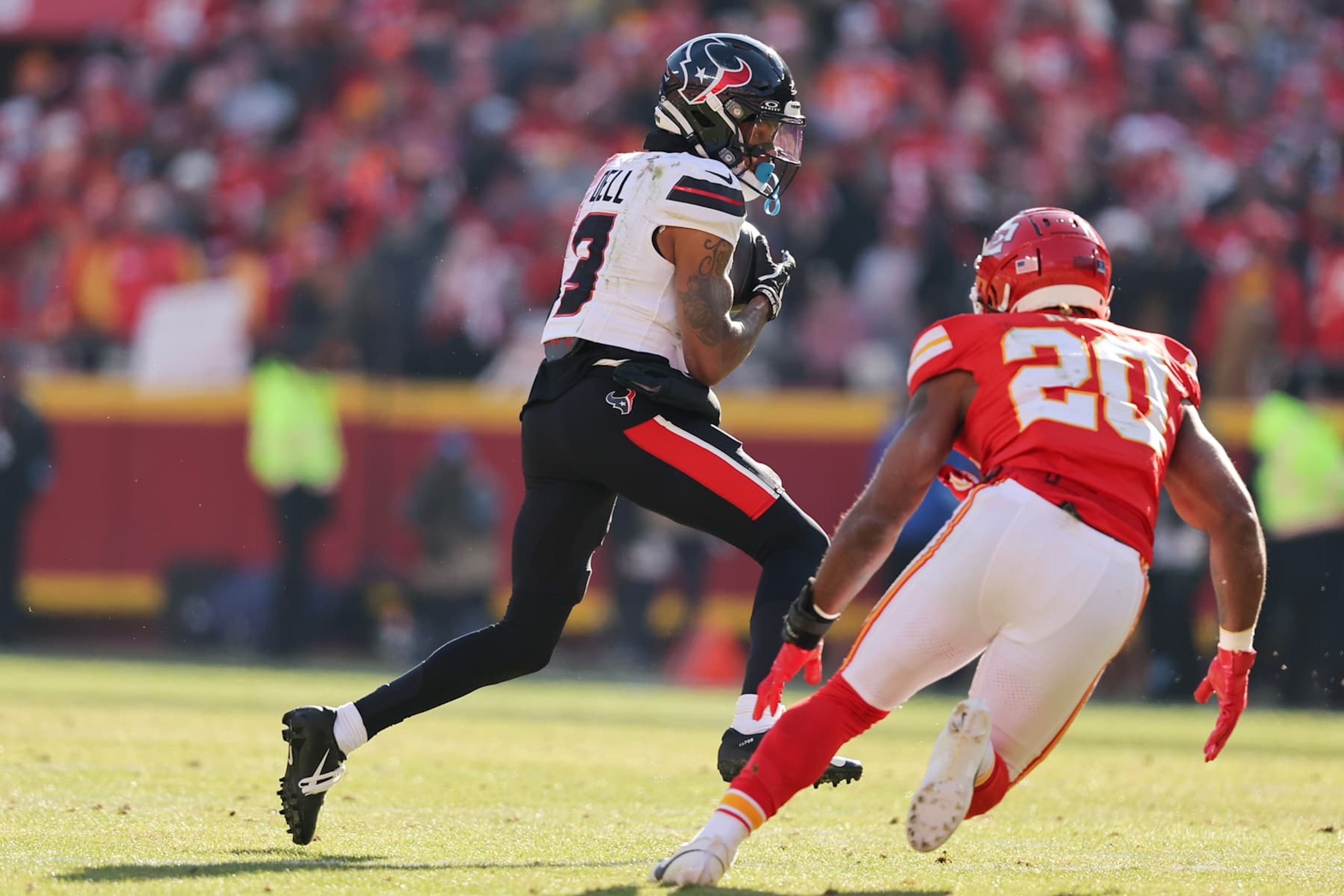 KANSAS CITY, MISSOURI - DECEMBER 21: Tank Dell #3 of the Houston Texans catches a pass against Justin Reid #20 of the Kansas City Chiefs in the second quarter of a game at GEHA Field at Arrowhead Stadium on December 21, 2024 in Kansas City, Missouri. (Photo by David Eulitt/Getty Images)