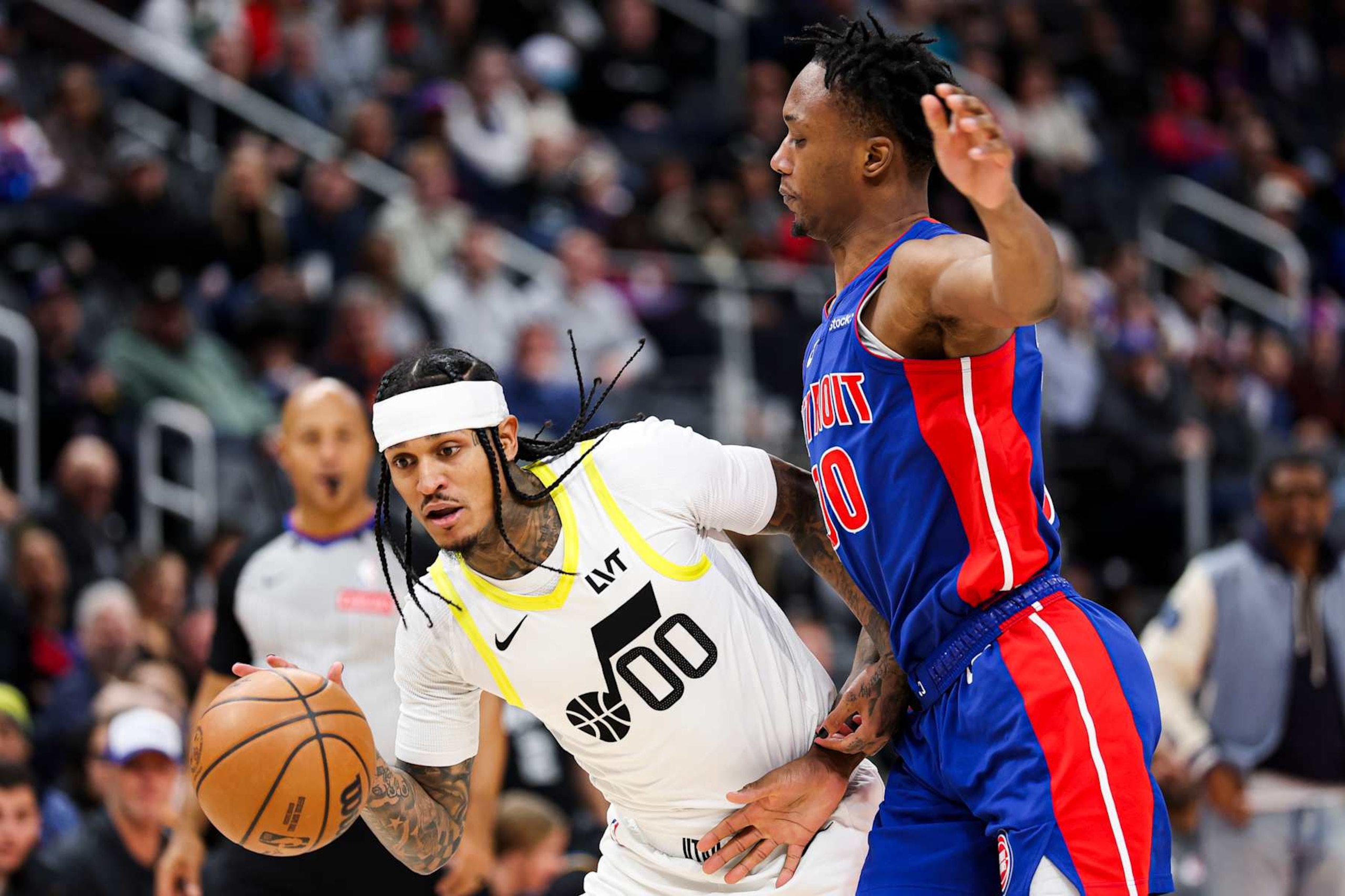 DETROIT, MICHIGAN - DECEMBER 19: Jordan Clarkson #00 of the Utah Jazz drives the ball against Ron Holland II #00 of the Detroit Pistons during the third quarter of a game at Little Caesars Arena on December 19, 2024 in Detroit, Michigan. NOTE TO USER: User expressly acknowledges and agrees that, by downloading and or using this photograph, User is consenting to the terms and conditions of the Getty Images License Agreement. (Photo by Mike Mulholland/Getty Images)