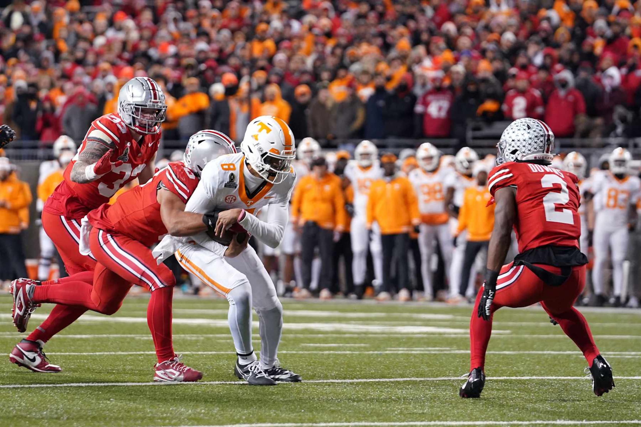 COLUMBUS, OHIO - DECEMBER 21: Nico Iamaleava #8 of the Tennessee Volunteers is tackled by Jack Sawyer #33 of the Ohio State Buckeyes during the second quarter in the Playoff First Round Game at Ohio Stadium on December 21, 2024 in Columbus, Ohio. (Photo by Jason Mowry/Getty Images) COLUMBUS, OHIO - DECEMBER 21: Nico Iamaleava #8 of the Tennessee Volunteers is tackled by Jack Sawyer #33 of the Ohio State Buckeyes during the second quarter in the Playoff First Round Game at Ohio Stadium on December 21, 2024 in Columbus, Ohio. (Photo by Jason Mowry/Getty Images)