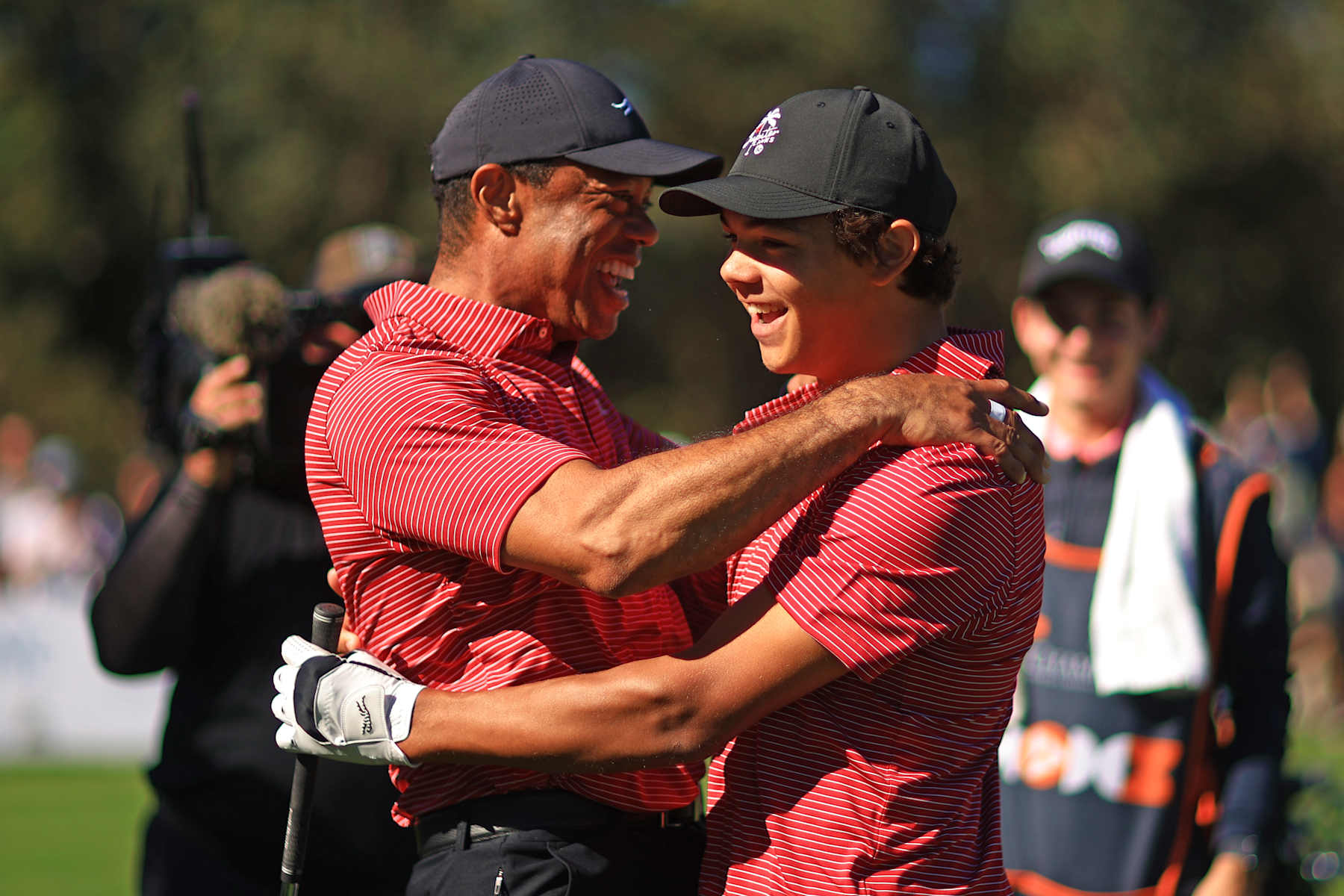 ORLANDO, FLORIDA - DECEMBER 22: Tiger Woods of the United States reacts with his son Charlie Woods after making the first hole-in-one of his career on the fourth hole during the second round of the PNC Championship at Ritz-Carlton Golf Club on December 22, 2024 in Orlando, Florida. (Photo by Mike Ehrmann/Getty Images)