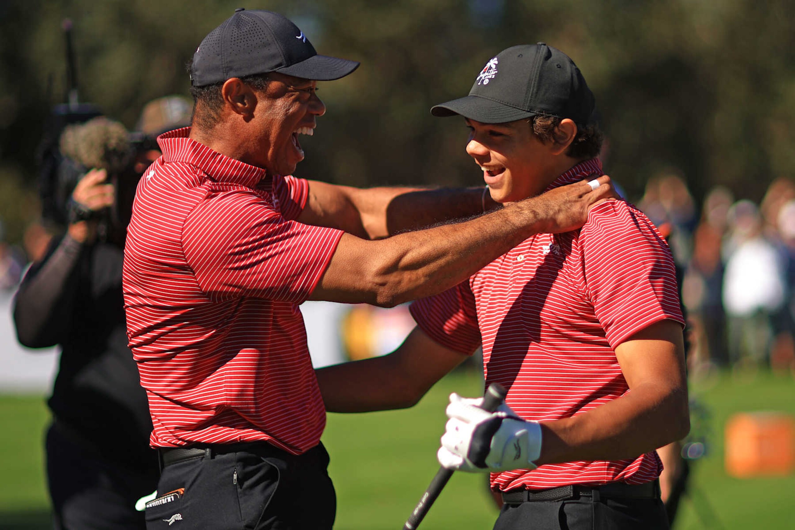 ORLANDO, FLORIDA - DECEMBER 22: Tiger Woods of the United States reacts with his son Charlie Woods after making the first hole-in-one of his career on the fourth hole during the second round of the PNC Championship at Ritz-Carlton Golf Club on December 22, 2024 in Orlando, Florida. (Photo by Mike Ehrmann/Getty Images)