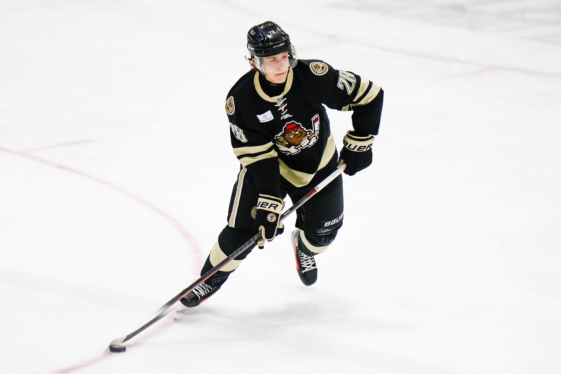 PLYMOUTH, MI - OCTOBER 18: Luka Radivojevic #28 of Muskegon gets ready to pass the puck during a game between Muskegon Lumberjacks and USNTDP U17 at USA Hockey Arena on October 18, 2024 in Plymouth, Michigan. (Photo by Michael Miller/ISI Photos/Getty Images)
