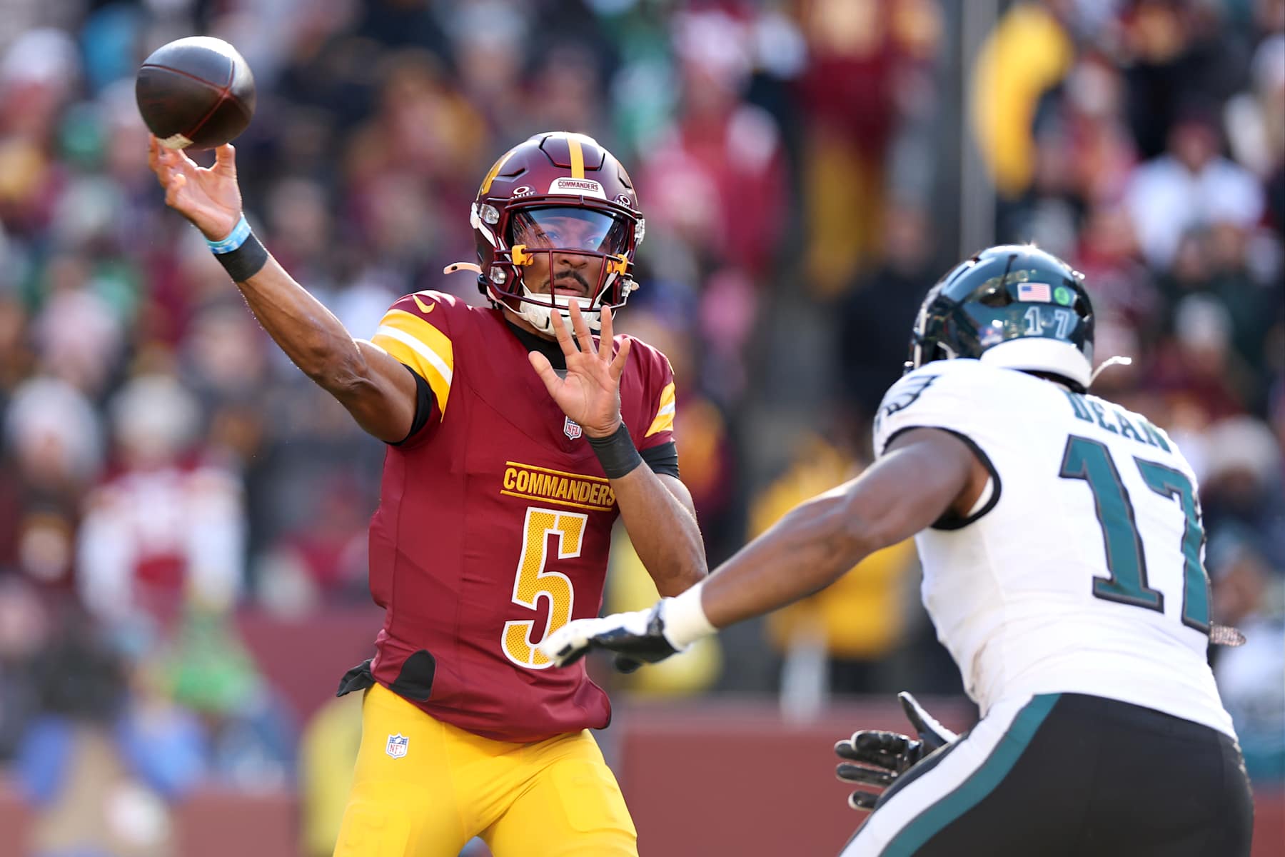 LANDOVER, MARYLAND - DECEMBER 22:  Jayden Daniels #5 of the Washington Commanders attempts a pass against the Philadelphia Eagles during the first quarter at Northwest Stadium on December 22, 2024 in Landover, Maryland. (Photo by Scott Taetsch/Getty Images)