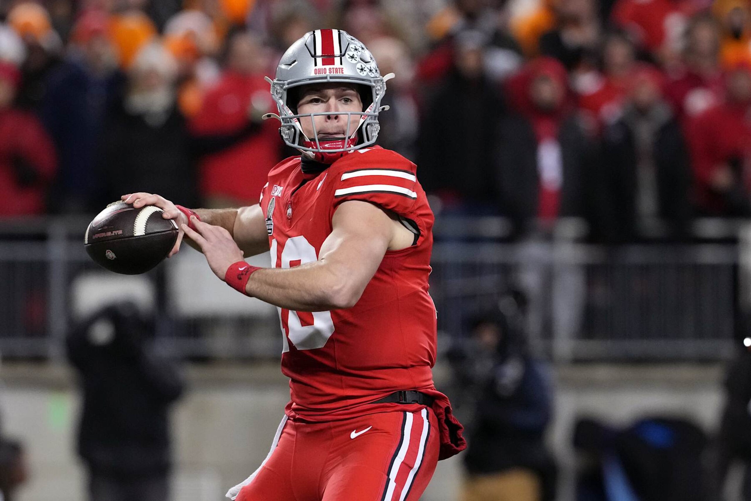 COLUMBUS, OHIO - DECEMBER 21: Will Howard #18 of the Ohio State Buckeyes throws a pass against the Tennessee Volunteers during the first quarter in the Playoff First Round Game at Ohio Stadium on December 21, 2024 in Columbus, Ohio. (Photo by Jason Mowry/Getty Images) COLUMBUS, OHIO - DECEMBER 21: Will Howard #18 of the Ohio State Buckeyes throws a pass against the Tennessee Volunteers during the first quarter in the Playoff First Round Game at Ohio Stadium on December 21, 2024 in Columbus, Ohio. (Photo by Jason Mowry/Getty Images)