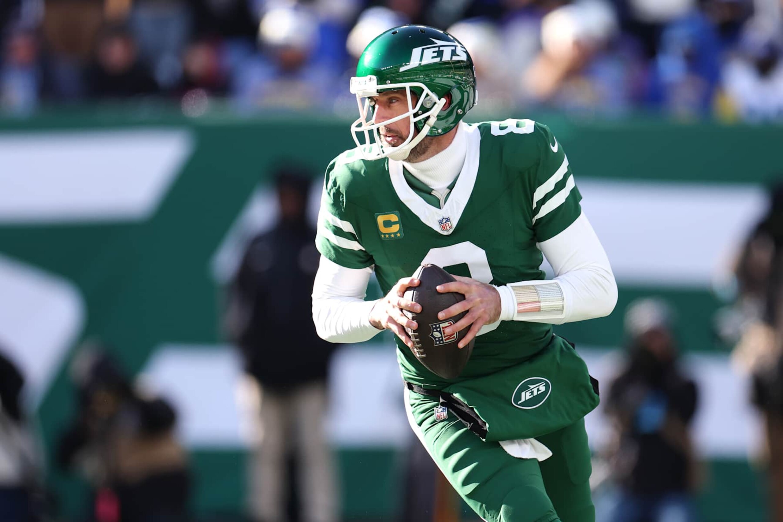 EAST RUTHERFORD, NEW JERSEY - DECEMBER 22: Aaron Rodgers #8 of the New York Jets looks to pass against the Los Angeles Rams during the first quarter at MetLife Stadium on December 22, 2024 in East Rutherford, New Jersey. (Photo by Emilee Chinn/Getty Images)