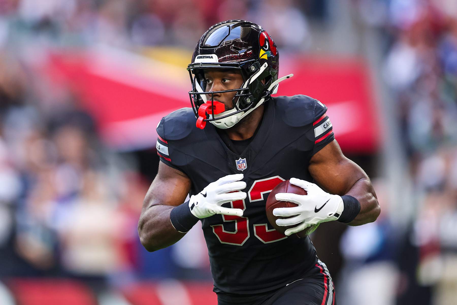 GLENDALE, ARIZONA - DECEMBER 8: Trey Benson #33 of the Arizona Cardinals runs the ball during the second quarter of a game against the Seattle Seahawks at State Farm Stadium on December 8, 2024 in Glendale, Arizona. (Photo by Mike Christy/Getty Images)