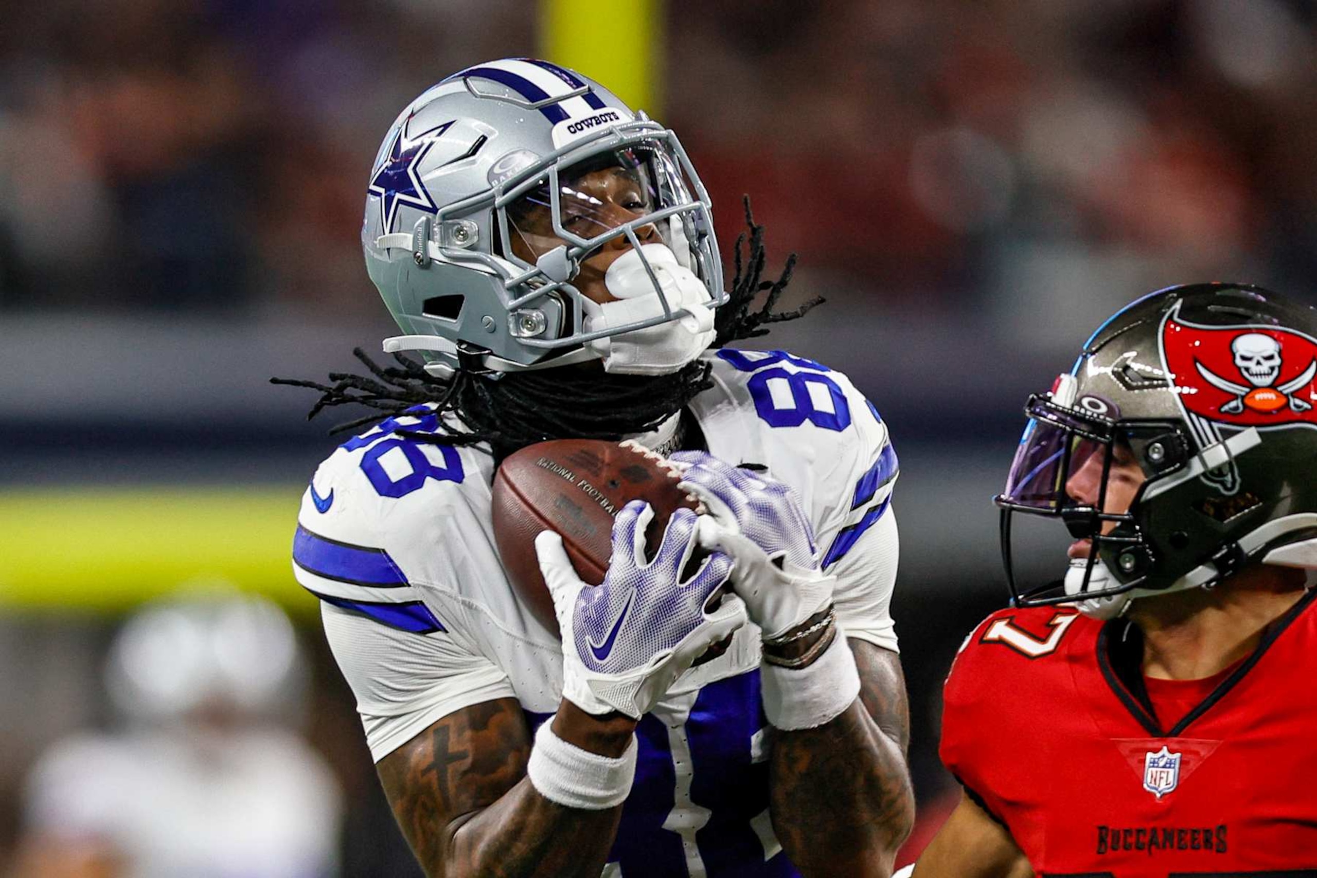 ARLINGTON, TX - DECEMBER 22: Dallas Cowboys wide receiver CeeDee Lamb (88) catches a pass over Tampa Bay Buccaneers cornerback Zyon McCollum (27) during the game between the Dallas Cowboys and the Tampa Bay Buccaneers on December 22, 2024 at AT&T Stadium in Arlington, Texas. (Photo by Matthew Pearce/Icon Sportswire via Getty Images) ARLINGTON, TX - DECEMBER 22: Dallas Cowboys wide receiver CeeDee Lamb (88) catches a pass over Tampa Bay Buccaneers cornerback Zyon McCollum (27) during the game between the Dallas Cowboys and the Tampa Bay Buccaneers on December 22, 2024 at AT&T Stadium in Arlington, Texas. (Photo by Matthew Pearce/Icon Sportswire via Getty Images)