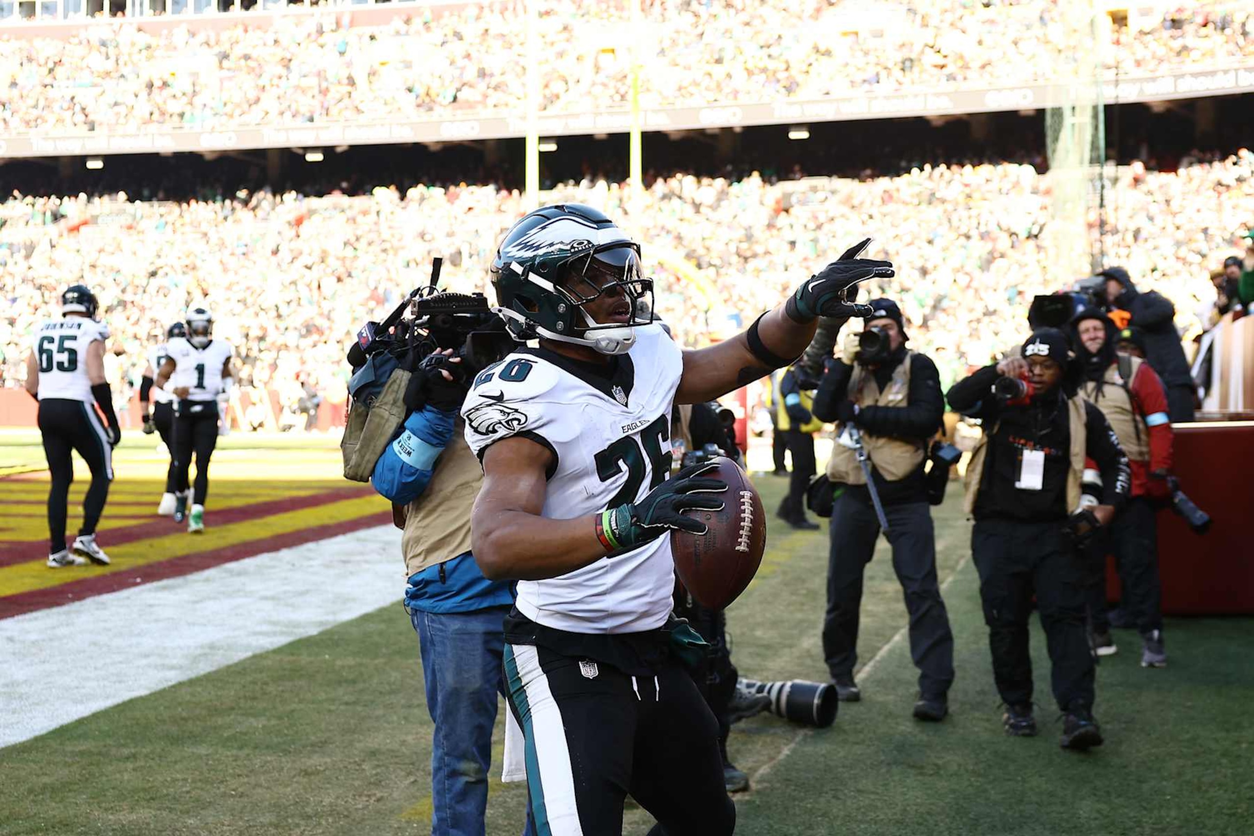 LANDOVER, MARYLAND - DECEMBER 22:  Saquon Barkley #26 of the Philadelphia Eagles celebrates after scoring a rushing touchdown against the Washington Commanders during the first quarter at Northwest Stadium on December 22, 2024 in Landover, Maryland. (Photo by Timothy Nwachukwu/Getty Images)