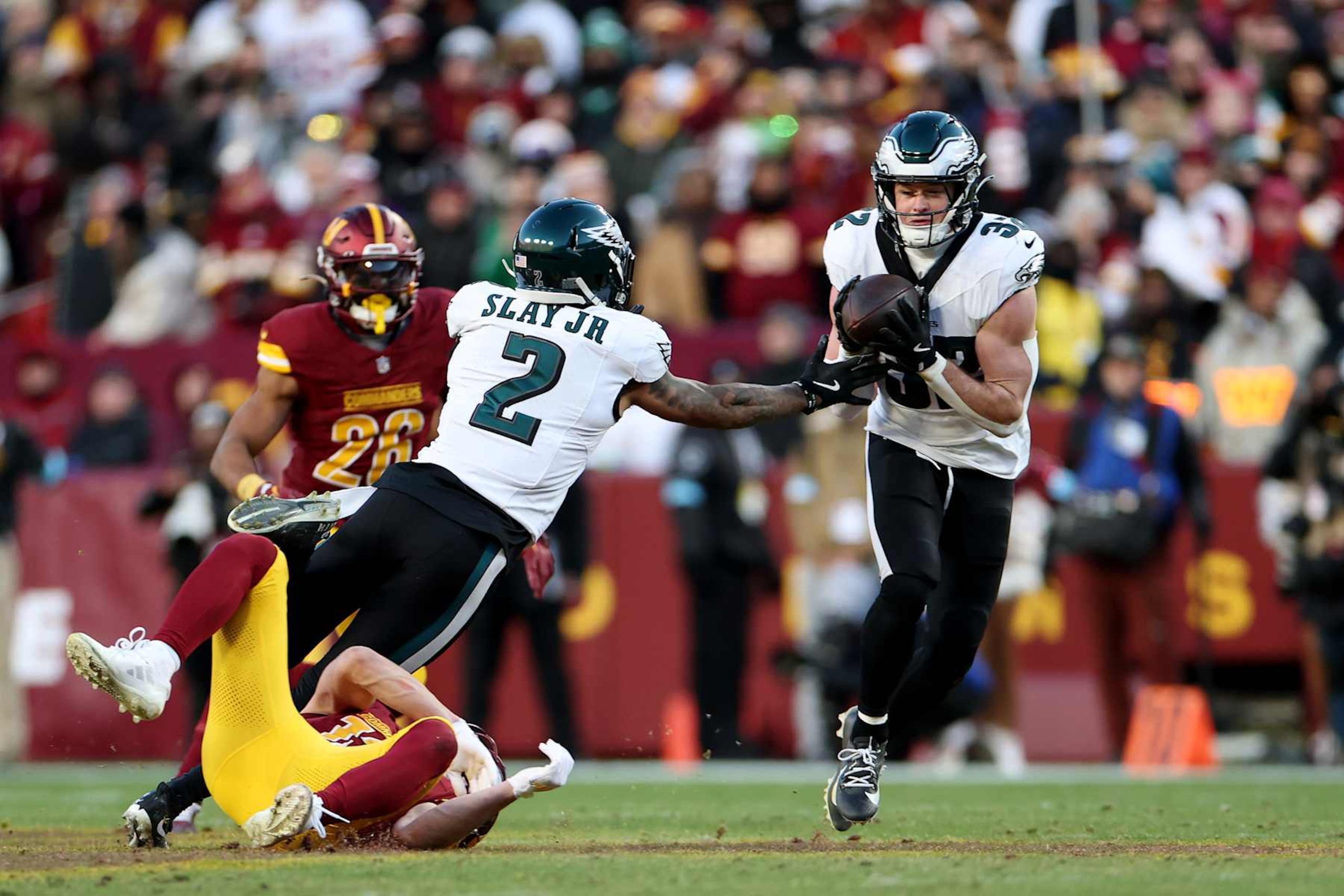LANDOVER, MARYLAND - DECEMBER 22:  Reed Blankenship #32 of the Philadelphia Eagles intercepts a pass intended for Luke McCaffrey #12 of the Washington Commanders during the fourth quarter at Northwest Stadium on December 22, 2024 in Landover, Maryland. (Photo by Scott Taetsch/Getty Images)