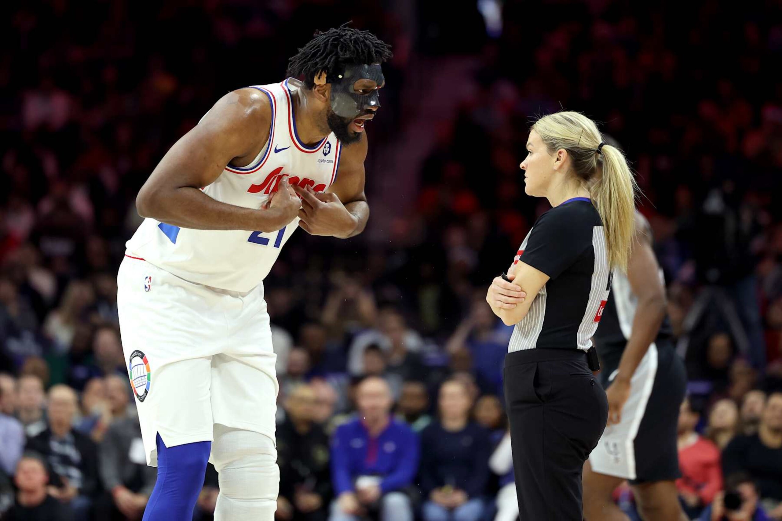 PHILADELPHIA, PENNSYLVANIA - DECEMBER 23: Joel Embiid #21 of the Philadelphia 76ers argues a call with referee Jenna Schroeder #20 during the first half against the San Antonio Spurs at the Wells Fargo Center on December 23, 2024 in Philadelphia, Pennsylvania. Embiid was ejected from the game with two technical fouls. NOTE TO USER: User expressly acknowledges and agrees that, by downloading and or using this photograph, User is consenting to the terms and conditions of the Getty Images License Agreement. (Photo by Emilee Chinn/Getty Images)
