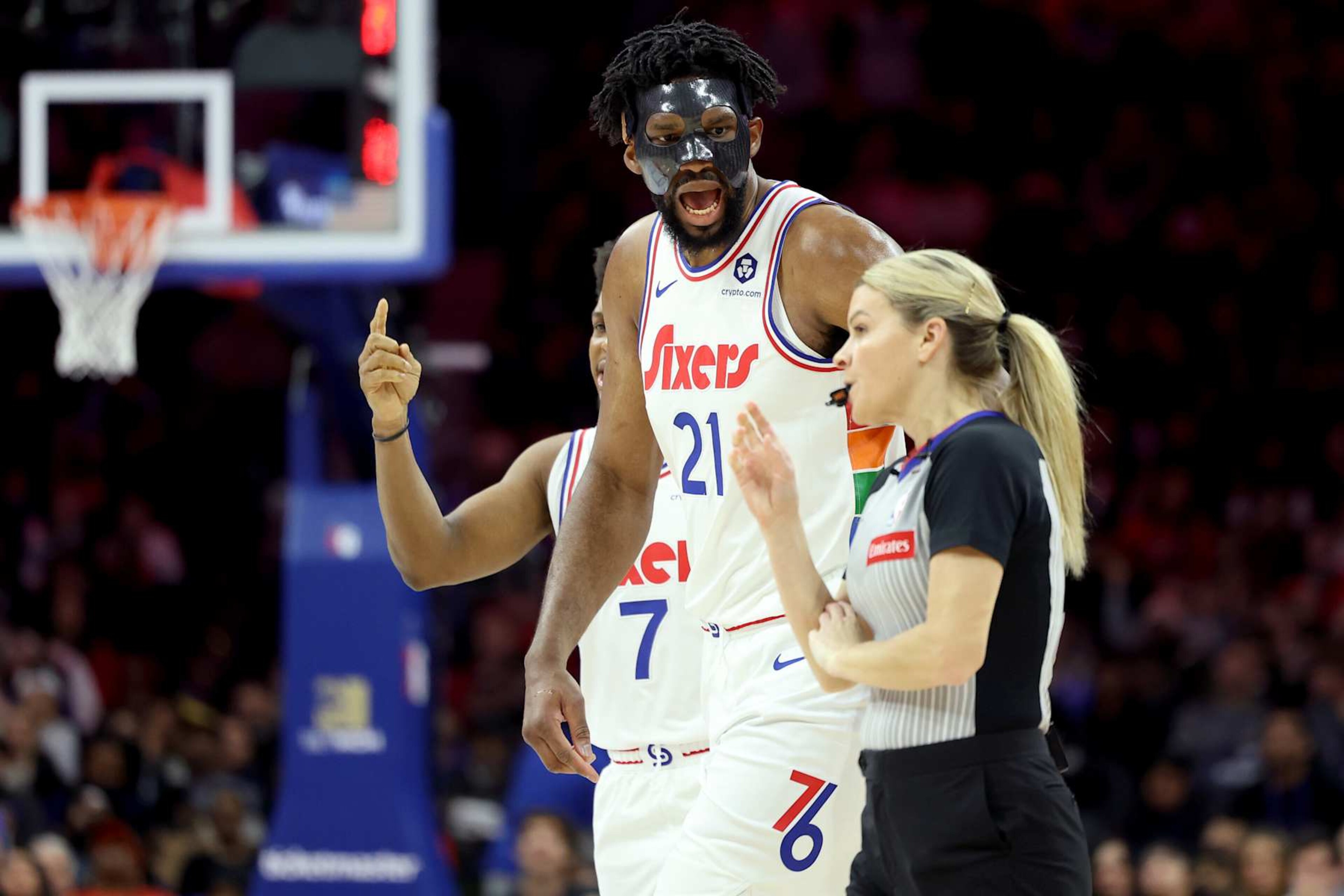 PHILADELPHIA, PENNSYLVANIA - DECEMBER 23: Joel Embiid #21 of the Philadelphia 76ers argues a call with referee Jenna Schroeder #20 during the first half against the San Antonio Spurs at the Wells Fargo Center on December 23, 2024 in Philadelphia, Pennsylvania. Embiid was ejected from the game with two technical fouls. NOTE TO USER: User expressly acknowledges and agrees that, by downloading and or using this photograph, User is consenting to the terms and conditions of the Getty Images License Agreement. (Photo by Emilee Chinn/Getty Images)
