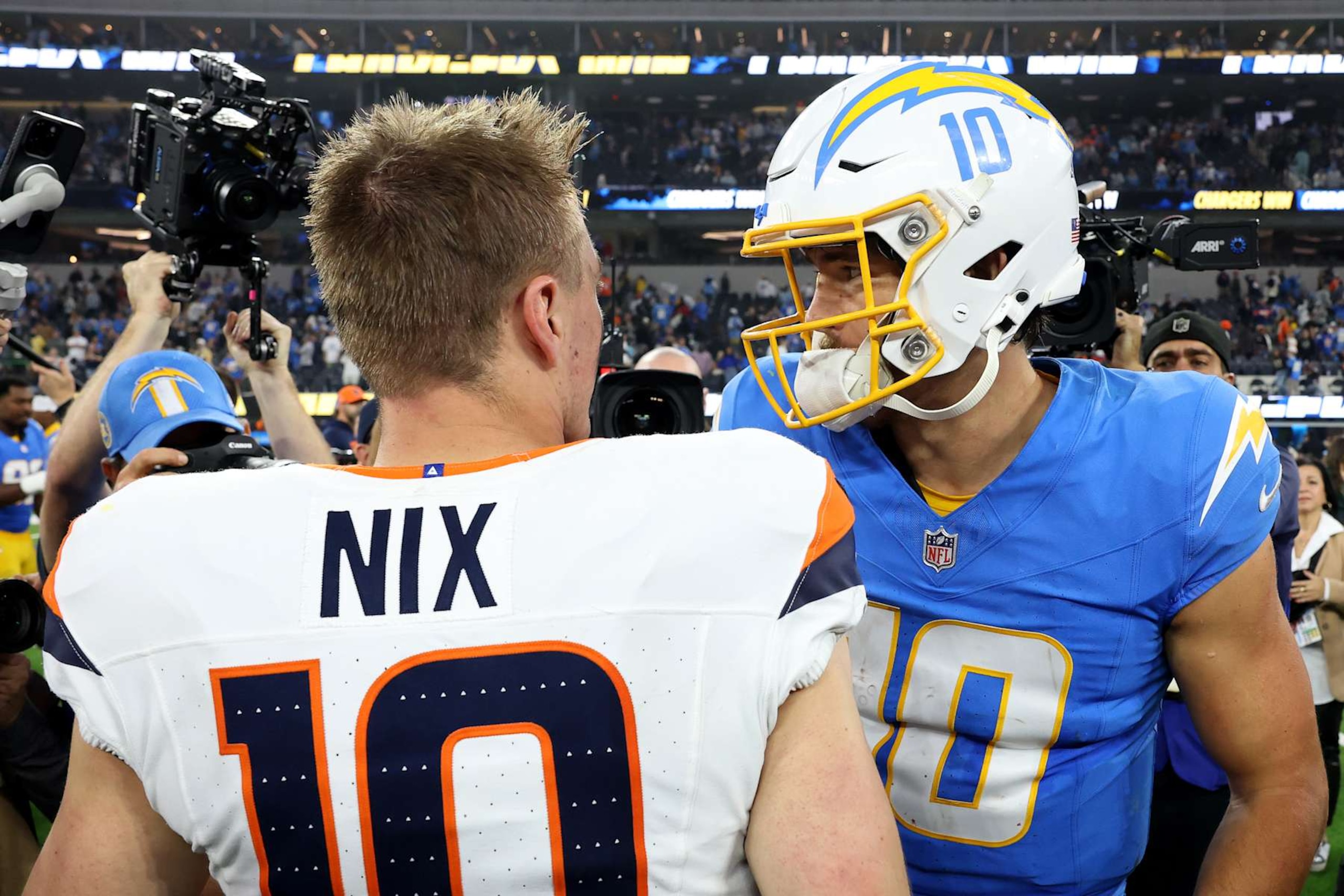 INGLEWOOD, CALIFORNIA - DECEMBER 19: Justin Herbert #10 of the Los Angeles Chargers talks with Bo Nix #10 of the Denver Broncos after the game at SoFi Stadium on December 19, 2024 in Inglewood, California. (Photo by Sean M. Haffey/Getty Images)
