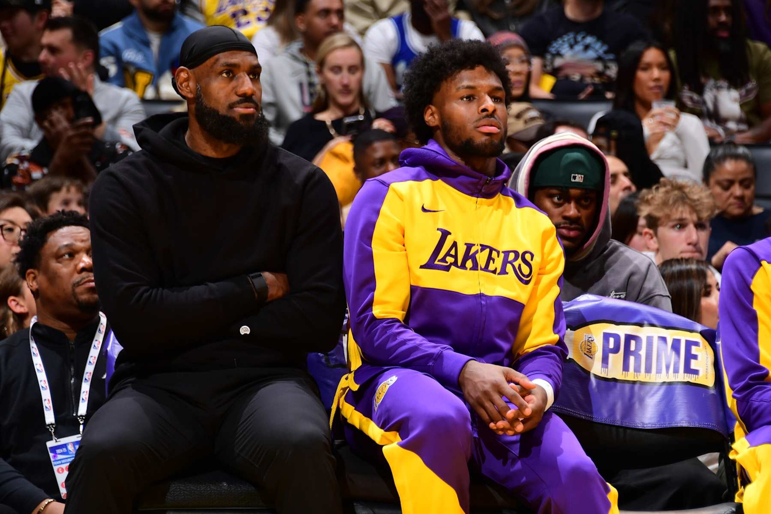 LOS ANGELES, CA - DECEMBER 8: LeBron James #23 and Bronny James #9 of the Los Angeles Lakers look on during the game against the Portland Trail Blazers on December 8, 2024 at Crypto.Com Arena in Los Angeles, California. NOTE TO USER: User expressly acknowledges and agrees that, by downloading and/or using this Photograph, user is consenting to the terms and conditions of the Getty Images License Agreement. Mandatory Copyright Notice: Copyright 2024 NBAE (Photo by Adam Pantozzi/NBAE via Getty Images)