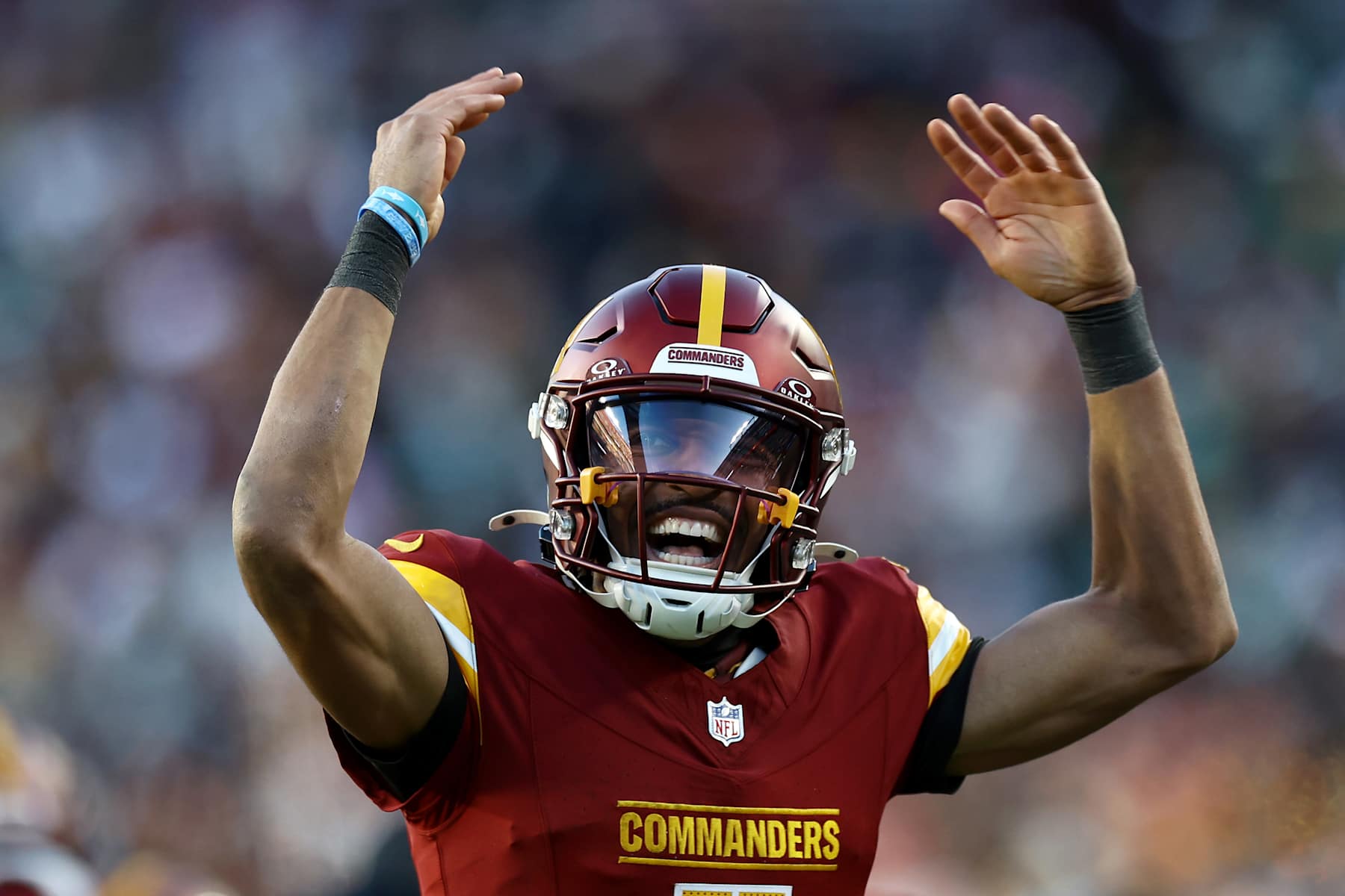 LANDOVER, MARYLAND - DECEMBER 22:  Jayden Daniels #5 of the Washington Commanders celebrates his touchdown pass against the Philadelphia Eagles during the fourth quarter at Northwest Stadium on December 22, 2024 in Landover, Maryland. (Photo by Timothy Nwachukwu/Getty Images)