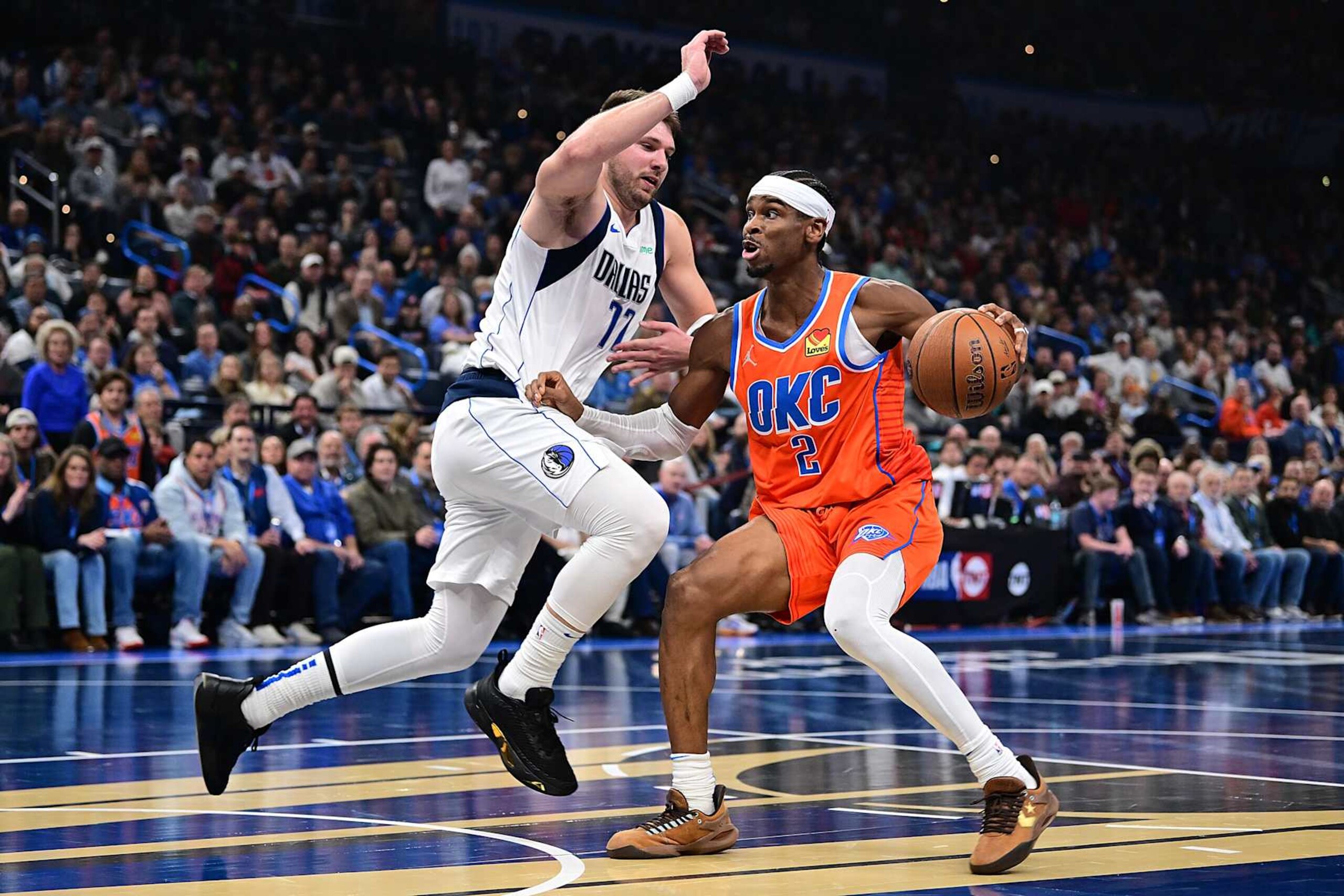 OKLAHOMA CITY, OKLAHOMA - DECEMBER 10: Shai Gilgeous-Alexander #2 of the Oklahoma City Thunder handles the ball in front of Luka Doncic #77 of the Dallas Mavericks during the first half at Paycom Center on December 10, 2024 in Oklahoma City, Oklahoma. NOTE TO USER: User expressly acknowledges and agrees that, by downloading and or using this photograph, User is consenting to the terms and conditions of the Getty Images License Agreement. (Photo by Joshua Gateley/Getty Images) OKLAHOMA CITY, OKLAHOMA - DECEMBER 10: Shai Gilgeous-Alexander #2 of the Oklahoma City Thunder handles the ball in front of Luka Doncic #77 of the Dallas Mavericks during the first half at Paycom Center on December 10, 2024 in Oklahoma City, Oklahoma. NOTE TO USER: User expressly acknowledges and agrees that, by downloading and or using this photograph, User is consenting to the terms and conditions of the Getty Images License Agreement. (Photo by Joshua Gateley/Getty Images)