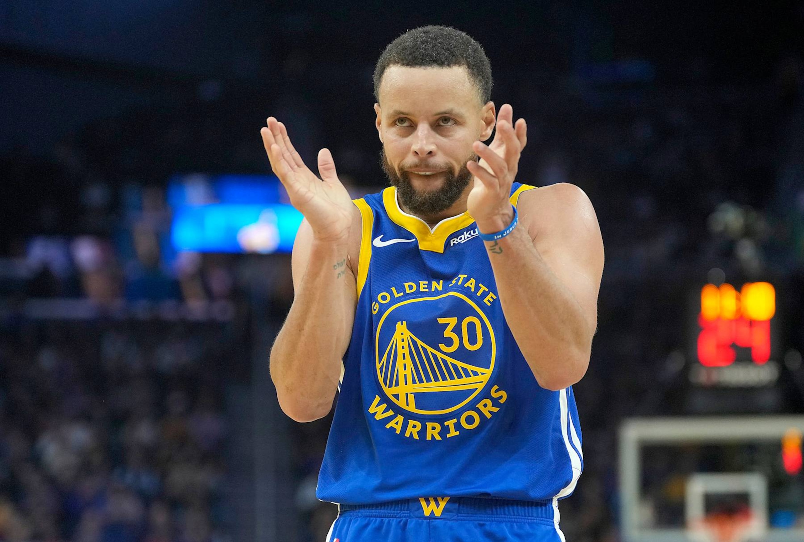 SAN FRANCISCO, CALIFORNIA - DECEMBER 23: Stephen Curry #30 of the Golden State Warriors reacts after teammate Andrew Wiggins #22 scores against the Indiana Pacers during the second half at Chase Center on December 23, 2024 in San Francisco, California. NOTE TO USER: User expressly acknowledges and agrees that, by downloading and or using this photograph, User is consenting to the terms and conditions of the Getty Images License Agreement. (Photo by Thearon W. Henderson/Getty Images)