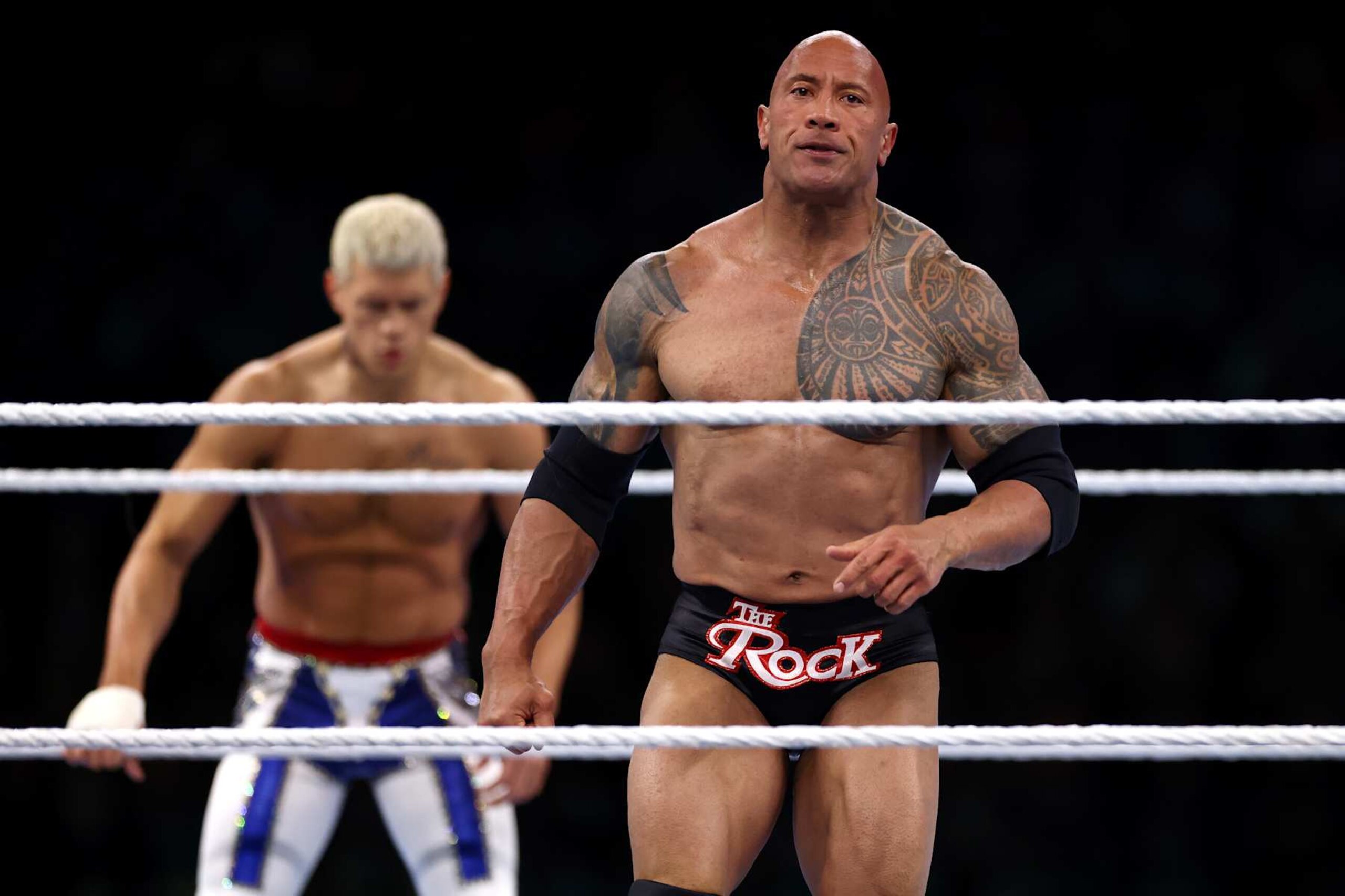 PHILADELPHIA, PENNSYLVANIA - APRIL 06: Dwayne "The Rock" Johnson reacts during a tag team fight with Romain Reigns against Cody Rhodes and Seth "Freakin" Rollins during Night One of WrestleMania 40 at Lincoln Financial Field on April 06, 2024 in Philadelphia, Pennsylvania.  (Photo by Tim Nwachukwu/Getty Images)