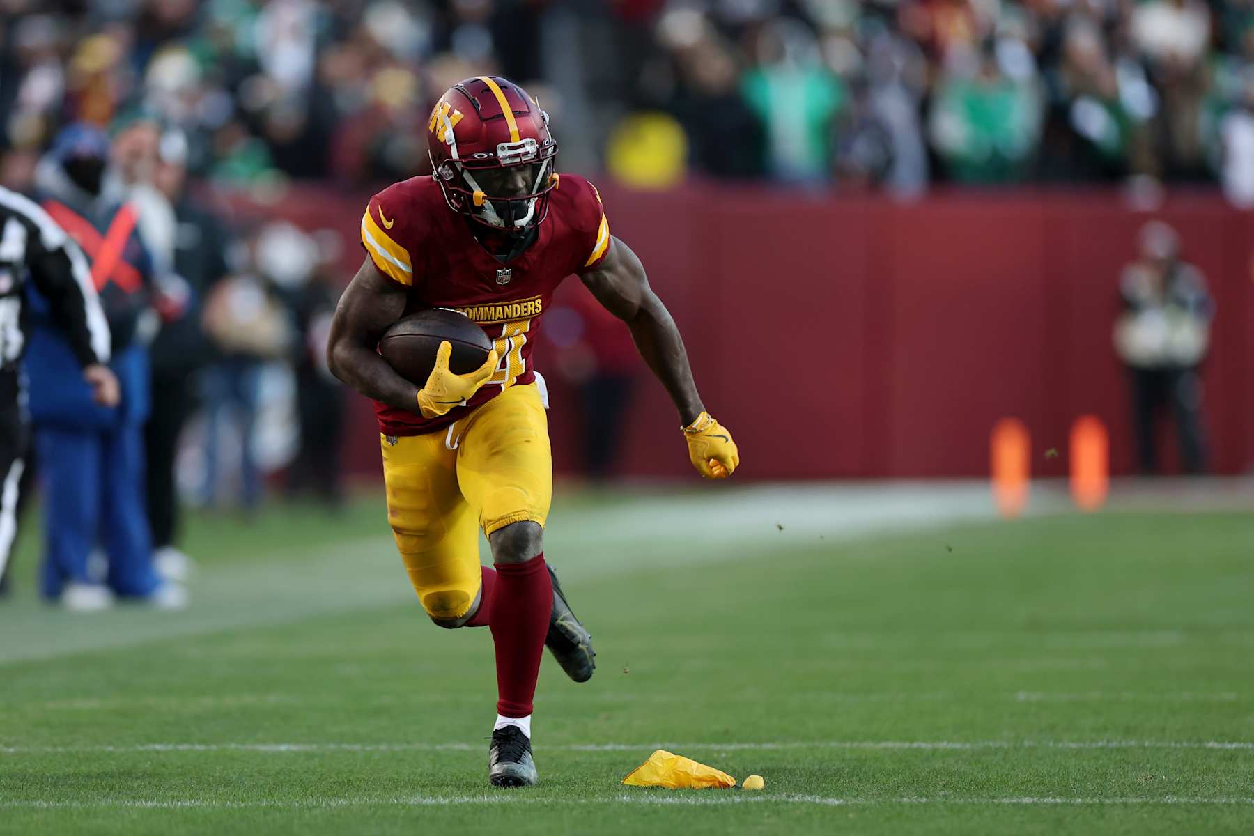 LANDOVER, MARYLAND - DECEMBER 22:  Olamide Zaccheaus #14 of the Washington Commanders scores a touchdown reception against the Philadelphia Eagles during the fourth quarter at Northwest Stadium on December 22, 2024 in Landover, Maryland. (Photo by Scott Taetsch/Getty Images)