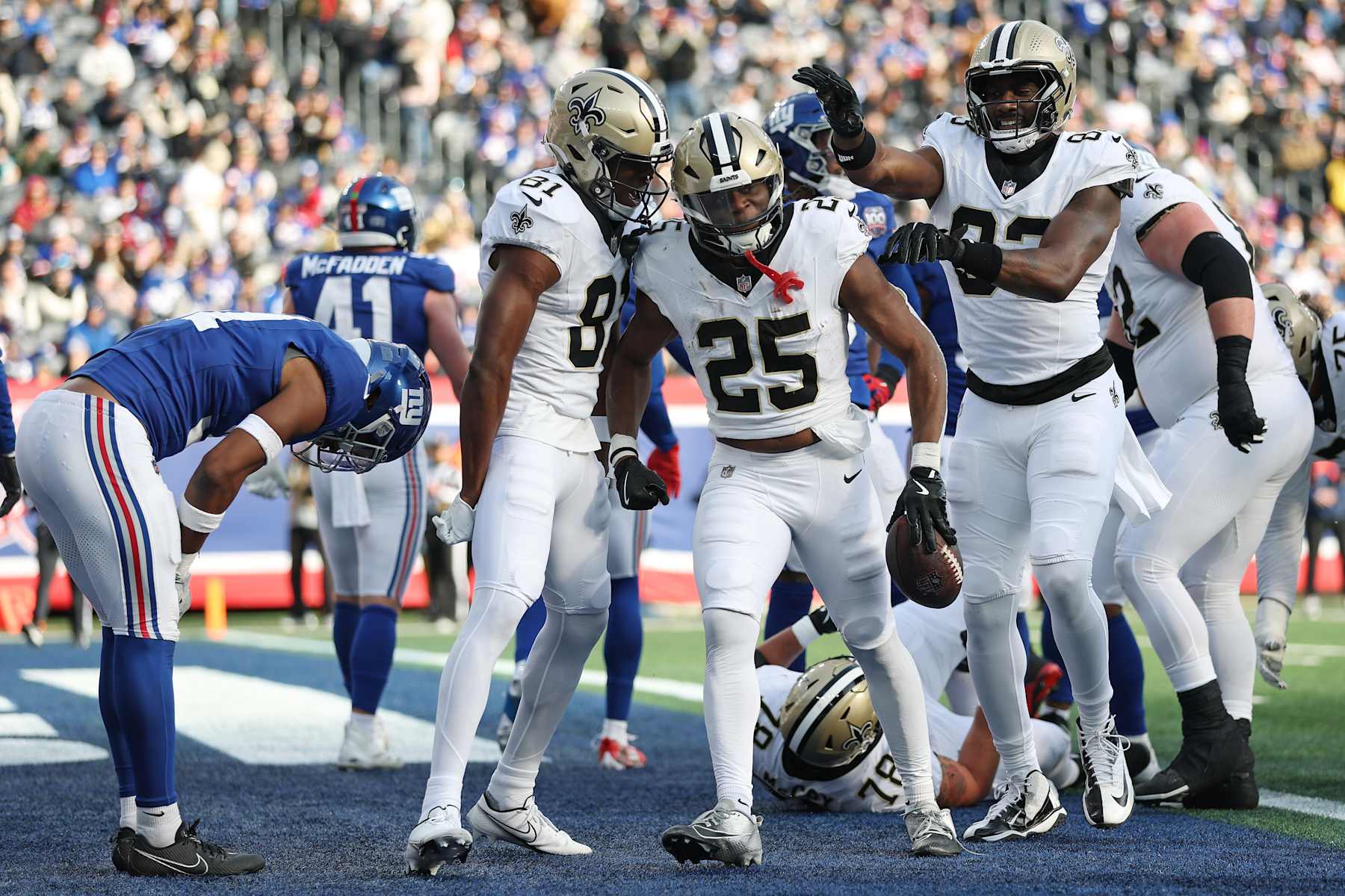EAST RUTHERFORD, NEW JERSEY - DECEMBER 08: Kendre Miller #25 of the New Orleans Saints celebrates a touchdown with teammates during the first quarter against the New York Giants at MetLife Stadium on December 08, 2024 in East Rutherford, New Jersey. (Photo by Sarah Stier/Getty Images)