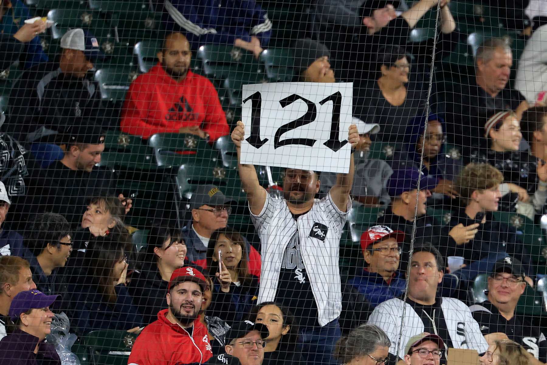 CHICAGO, ILLINOIS - SEPTEMBER 24: Chicago White Sox fans hold up a 121 sign during the sixth inning in the game between the Los Angeles Angels and the Chicago White Sox at Guaranteed Rate Field on September 24, 2024 in Chicago, Illinois. (Photo by Justin Casterline/Getty Images)
