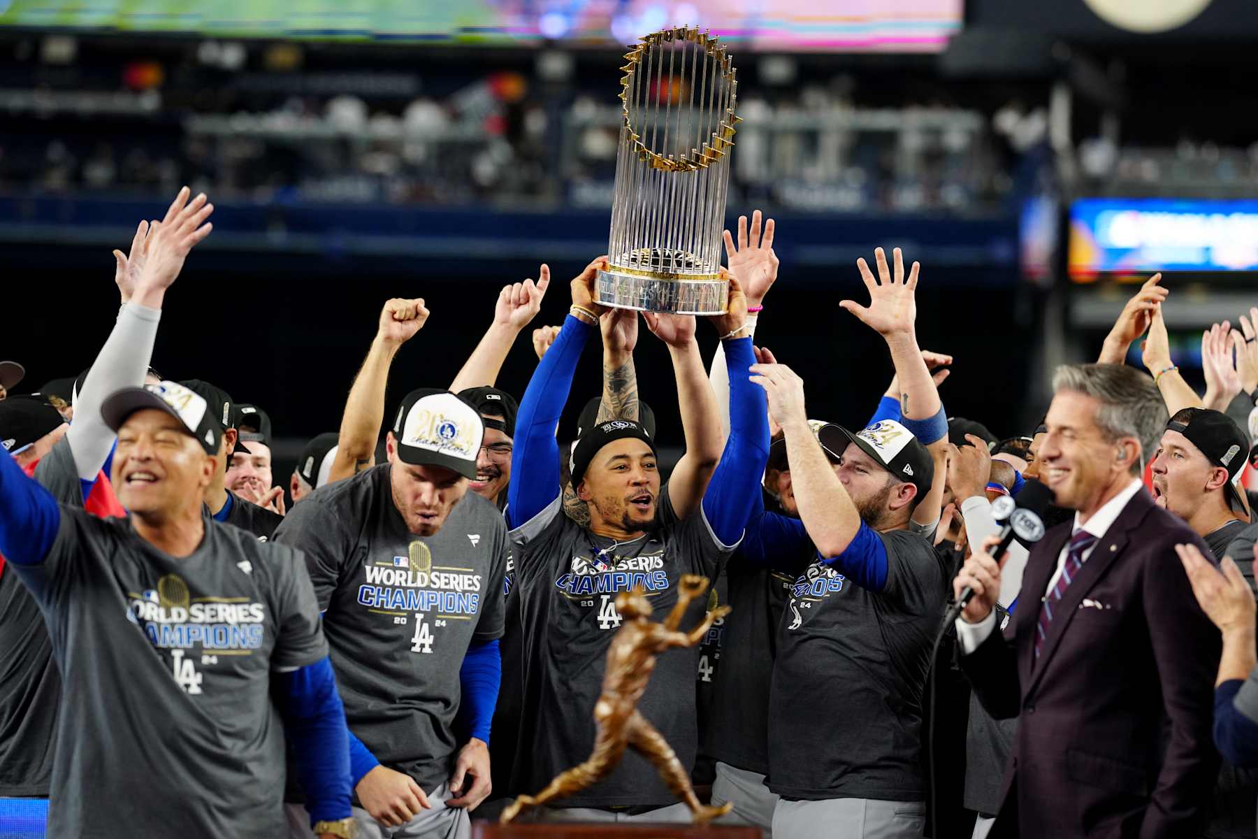 NEW YORK, NY - OCTOBER 30:  Mookie Betts #50 of the Los Angeles Dodgers hoists the Commissioner's Trophy after the Dodgers defeated the New York Yankees in Game 5 to clinch the 2024 World Series presented by Capital One at Yankee Stadium on Wednesday, October 30, 2024 in New York, New York. (Photo by Mary DeCicco/MLB Photos via Getty Images)
