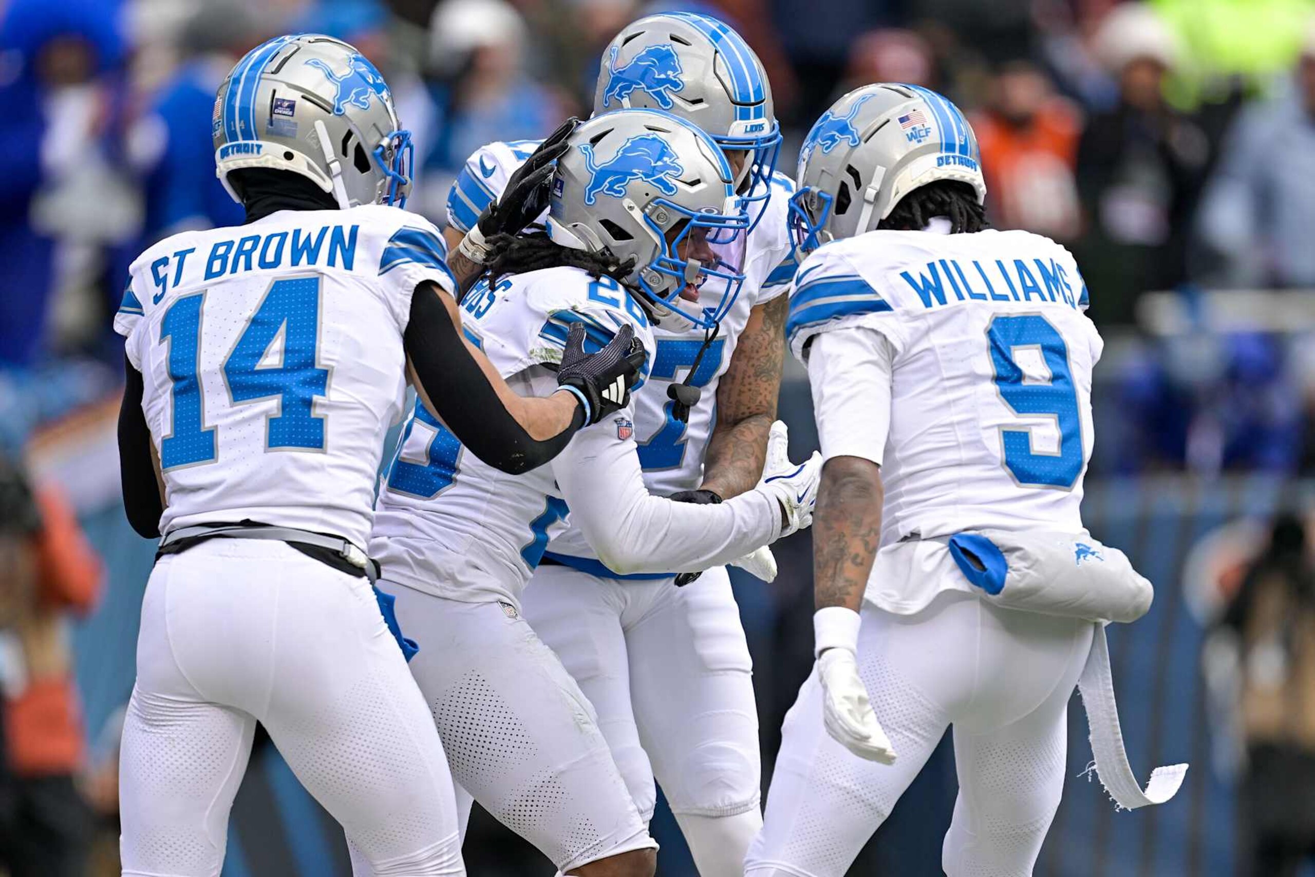 CHICAGO, ILLINOIS - DECEMBER 22: Jahmyr Gibbs #26 of the Detroit Lions celebrates his rushing touchdown against the Chicago Bears with Tim Patrick #17, Amon-Ra St. Brown #14, and Jameson Williams #9 of the Detroit Lions during the first quarter at Soldier Field on December 22, 2024 in Chicago, Illinois. (Photo by Quinn Harris/Getty Images)