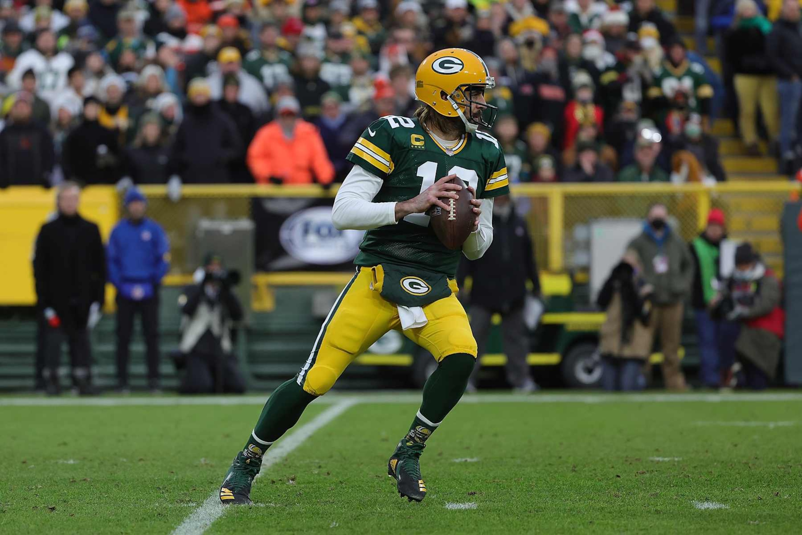 GREEN BAY, WISCONSIN - DECEMBER 25: Aaron Rodgers #12 of the Green Bay Packers drops back to pass during a game against the Cleveland Browns at Lambeau Field on December 25, 2021 in Green Bay, Wisconsin.  The Packers defeated the Browns 24-22. (Photo by Stacy Revere/Getty Images)