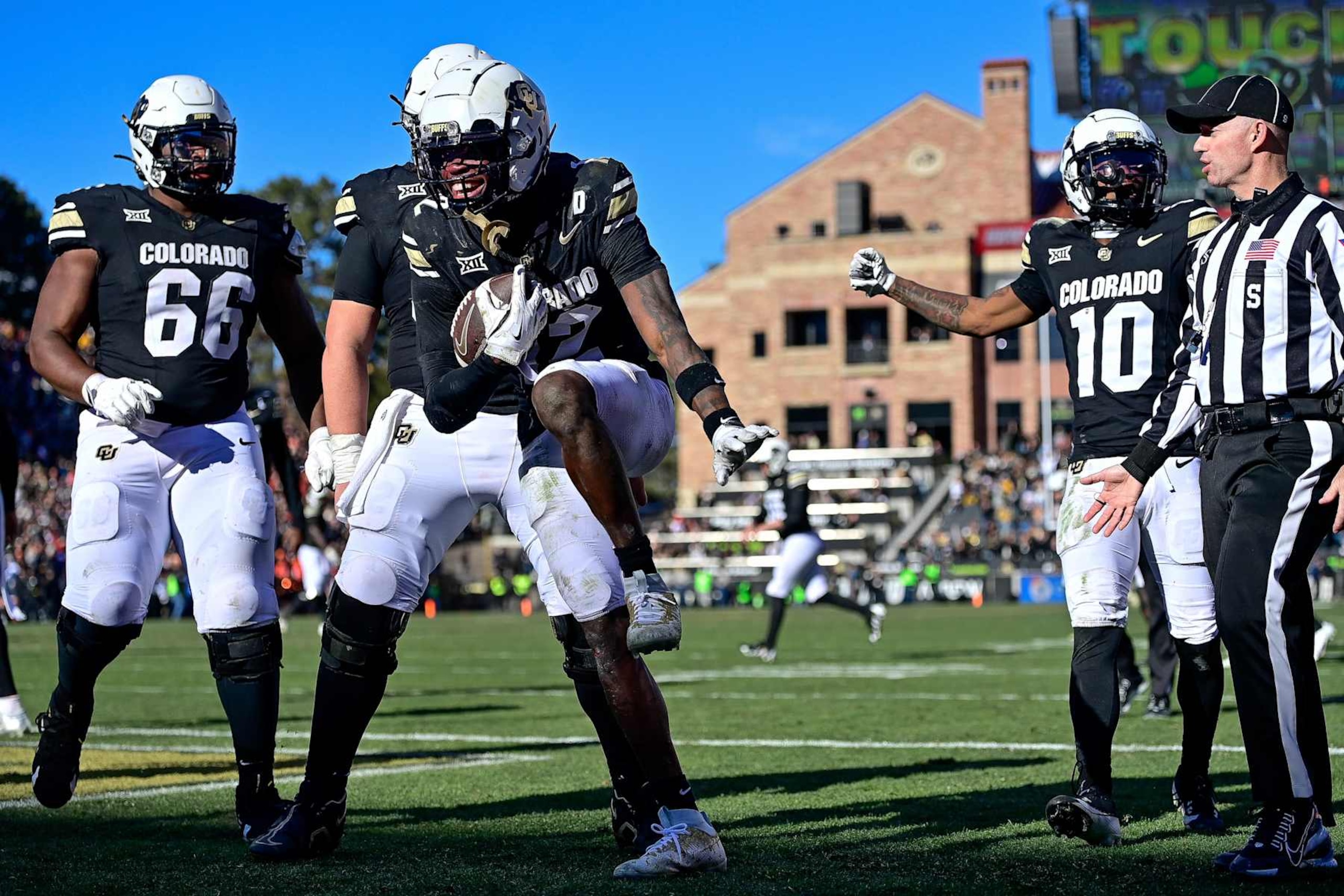 BOULDER, CO - NOVEMBER 29:  Travis Hunter #12 of the Colorado Buffaloes celebrates with the Heisman Trophy pose after catching a pass under tight coverage against the Oklahoma State Cowboys for a fourth quarter touchdown at Folsom Field on November 29, 2024 in Boulder, Colorado. (Photo by Dustin Bradford/Getty Images)