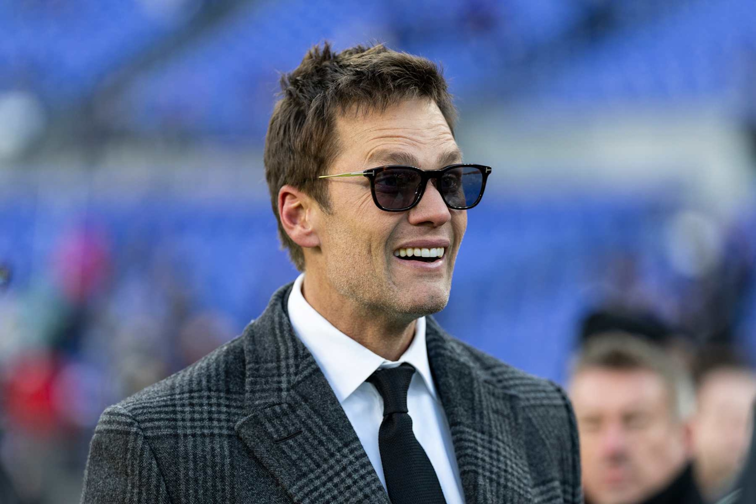 BALTIMORE, MARYLAND - DECEMBER 21: Former NFL quarterback Tom Brady reacts prior to an NFL Football game  at M&T Bank Stadium on December 21, 2024 in Baltimore, Maryland. (Photo by Michael Owens/Getty Images)