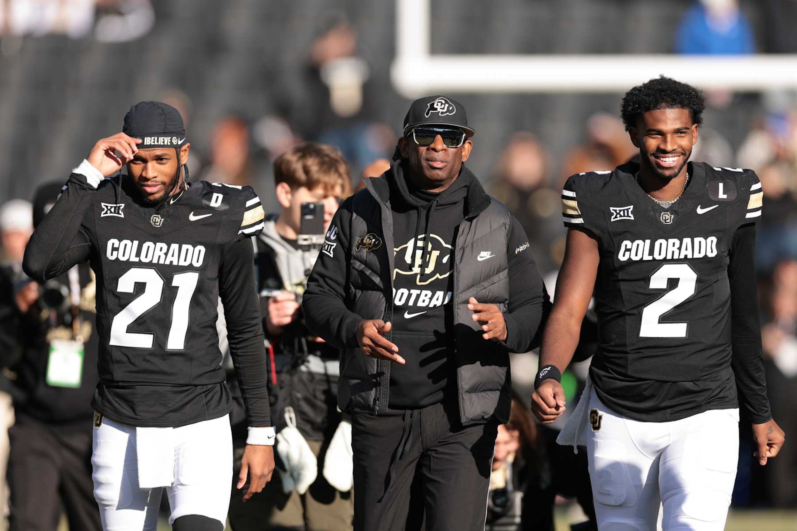 BOULDER, COLORADO - NOVEMBER 29: (L-R) Shilo Sanders #21, Head coach Deion Sanders and Shedeur Sanders #2 of the Colorado Buffaloes walk the field during senior day celebrations prior to the game against the Oklahoma State Cowboys at Folsom Field on November 29, 2024 in Boulder, Colorado. (Photo by Andrew Wevers/Getty Images) BOULDER, COLORADO - NOVEMBER 29: (L-R) Shilo Sanders #21, Head coach Deion Sanders and Shedeur Sanders #2 of the Colorado Buffaloes walk the field during senior day celebrations prior to the game against the Oklahoma State Cowboys at Folsom Field on November 29, 2024 in Boulder, Colorado. (Photo by Andrew Wevers/Getty Images)