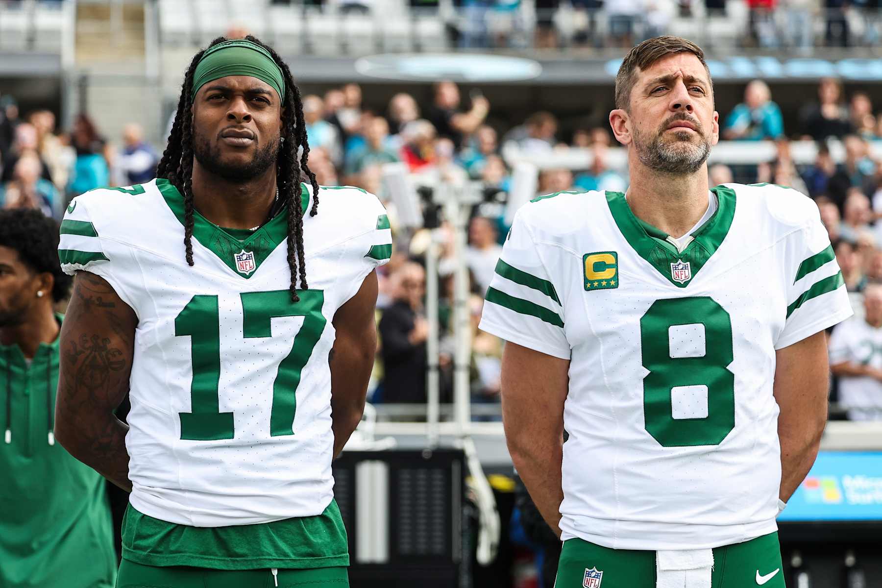 JACKSONVILLE, FLORIDA - DECEMBER 15: Davante Adams #17 of the New York Jets and Aaron Rodgers #8 look on from the sideline during the national anthem prior to an NFL football game against the Jacksonville Jaguars at EverBank Stadium on December 15, 2024 in Jacksonville, FL. (Photo by Perry Knotts/Getty Images)