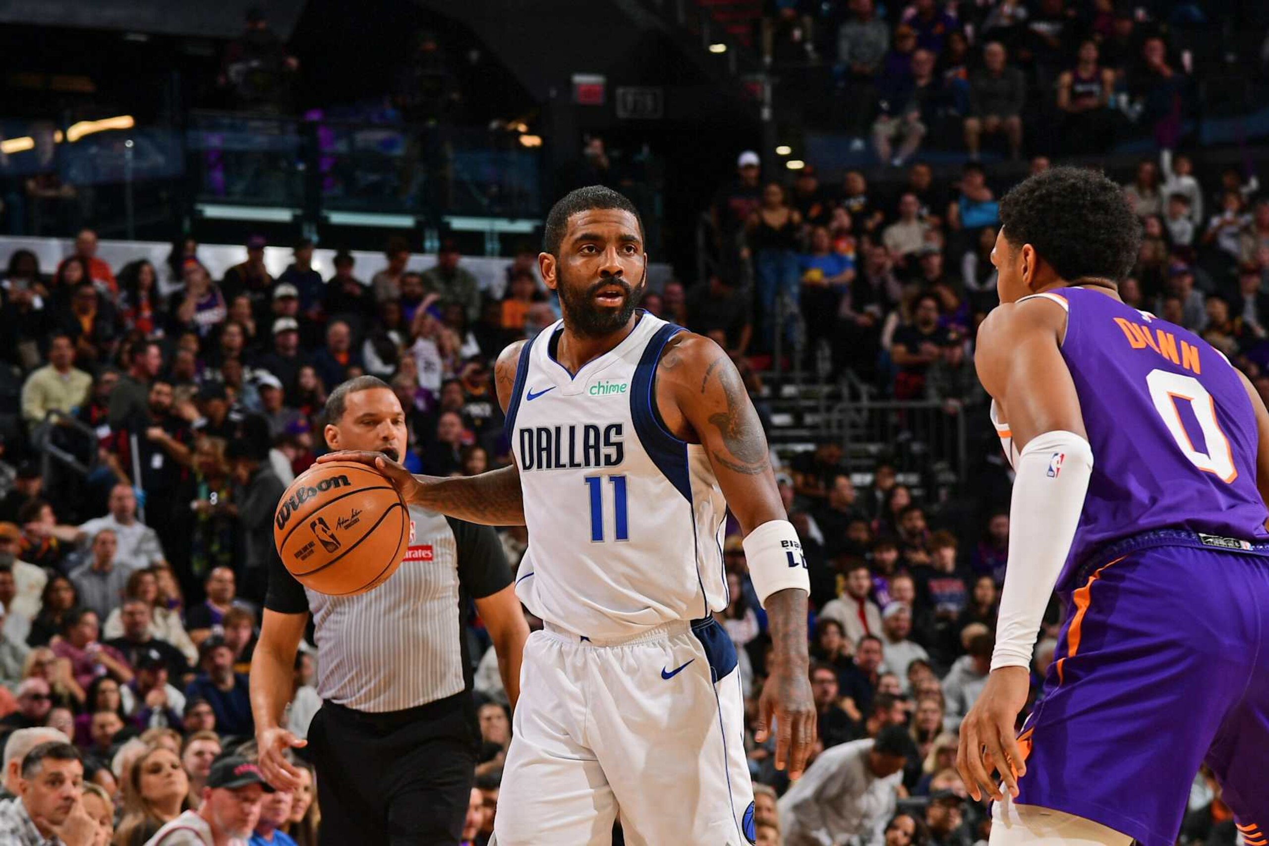 PHOENIX, AZ - DECEMBER 27: Kyrie Irving #11 of the Dallas Mavericks handles the ball during the game against the Phoenix Suns on December 27, 2024 at Footprint Center in Phoenix, Arizona. NOTE TO USER: User expressly acknowledges and agrees that, by downloading and or using this photograph, user is consenting to the terms and conditions of the Getty Images License Agreement. Mandatory Copyright Notice: Copyright 2024 NBAE (Photo by Kate Frese/NBAE via Getty Images)
