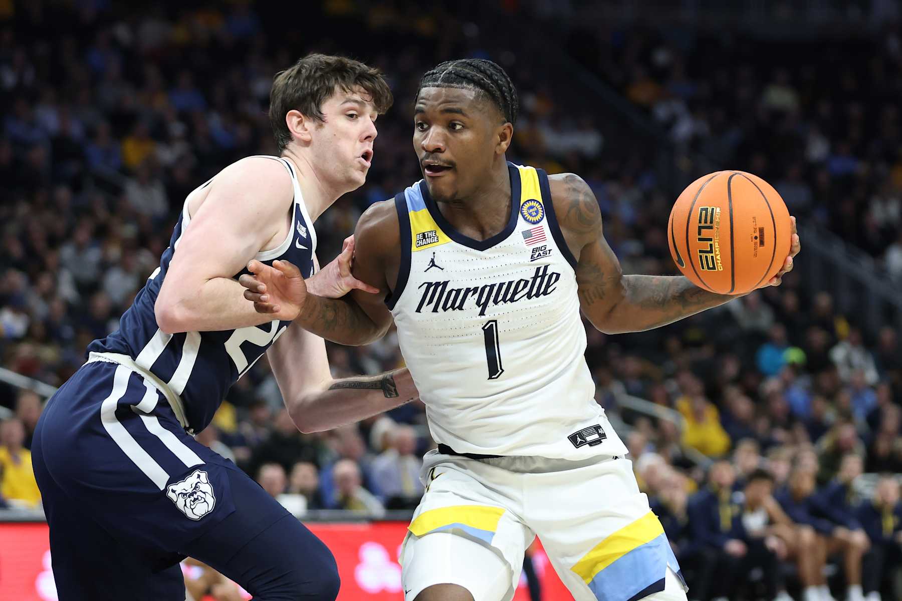 MILWAUKEE, WISCONSIN - DECEMBER 18: Kam Jones #1 of the Marquette Golden Eagles is defended by Patrick McCaffery #22 of the Butler Bulldogs during a game at Fiserv Forum on December 18, 2024 in Milwaukee, Wisconsin. (Photo by Stacy Revere/Getty Images)