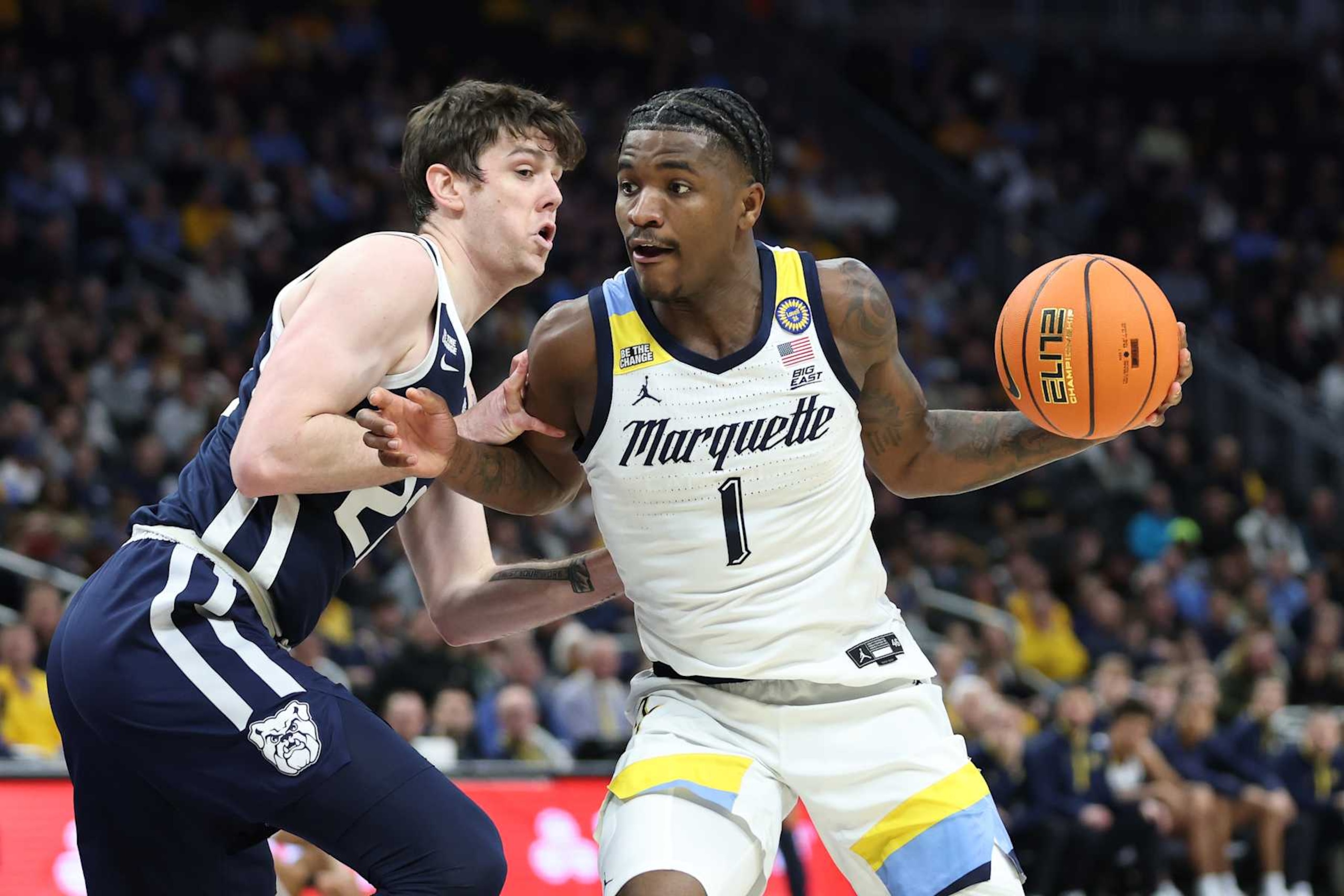 MILWAUKEE, WISCONSIN - DECEMBER 18: Kam Jones #1 of the Marquette Golden Eagles is defended by Patrick McCaffery #22 of the Butler Bulldogs during a game at Fiserv Forum on December 18, 2024 in Milwaukee, Wisconsin. (Photo by Stacy Revere/Getty Images)