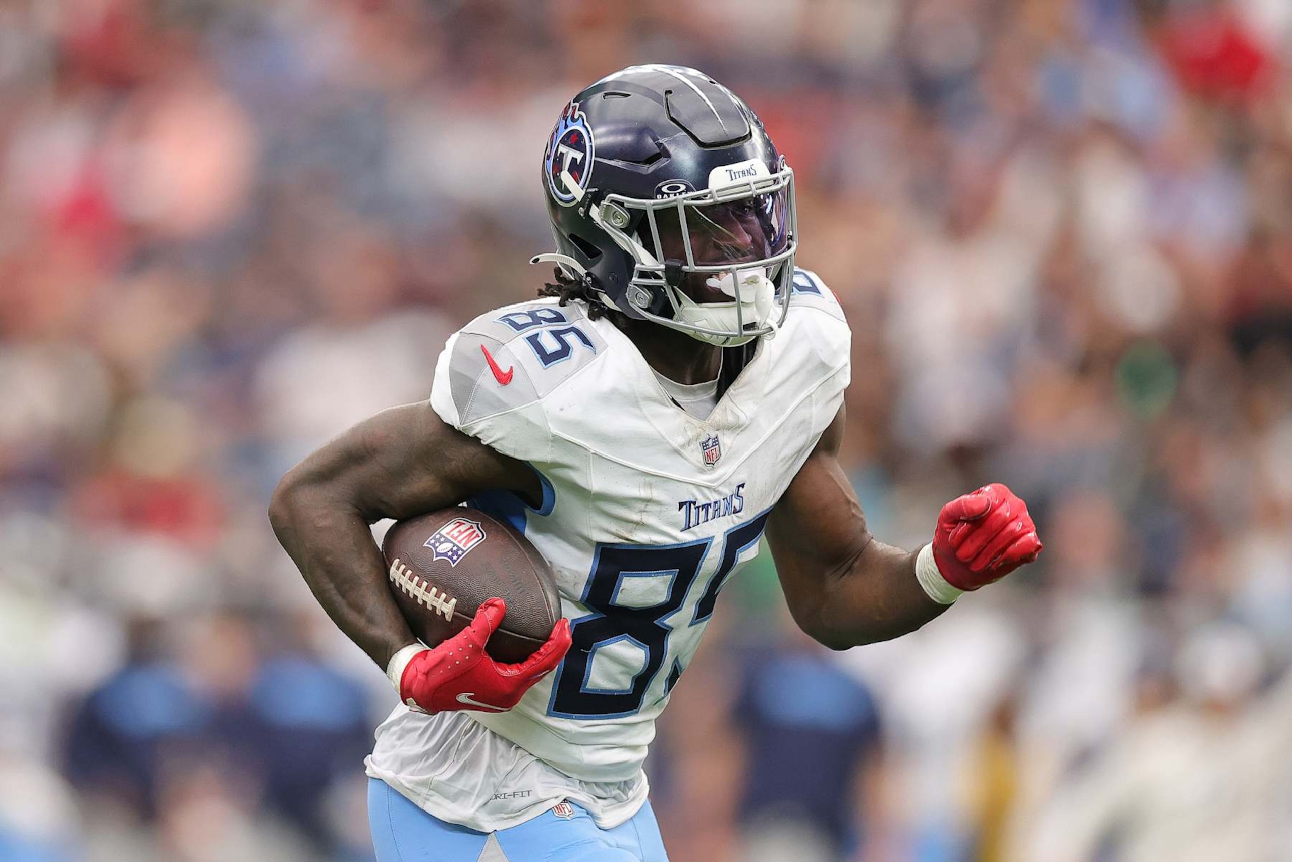 HOUSTON, TEXAS - NOVEMBER 24: Chig Okonkwo #85 of the Tennessee Titans runs the ball in for a touchdown against the Houston Texans during the fourth quarter at NRG Stadium on November 24, 2024 in Houston, Texas. (Photo by Alex Slitz/Getty Images)