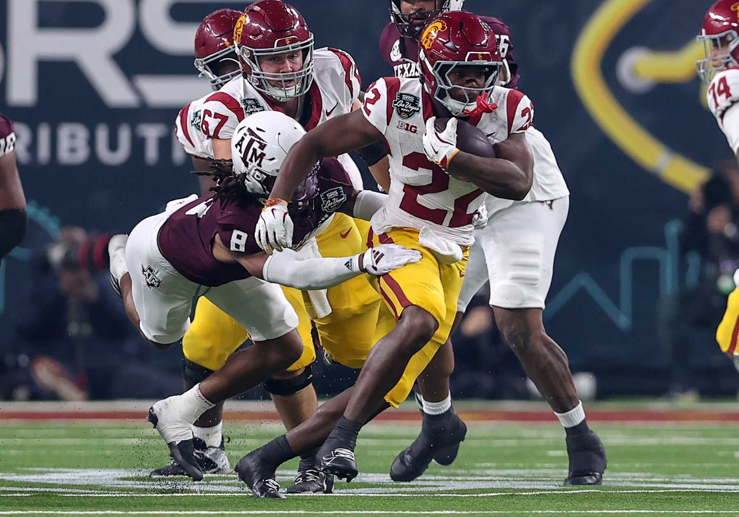 LAS VEGAS, NV - DECEMBER 27: USC Trojans running back A'Marion Peterson (22) breaks free from Texas A&M Aggies defensive back Jaydon Hill (8) during the SRS Distribution Las Vegas Bowl featuring the Texas A&M Aggies vs. the USC Trojans on December 27, 2024 at Allegiant Stadium in Las Vegas, Nevada. (Photo by Steve Nurenberg/Icon Sportswire via Getty Images) LAS VEGAS, NV - DECEMBER 27: USC Trojans running back A'Marion Peterson (22) breaks free from Texas A&M Aggies defensive back Jaydon Hill (8) during the SRS Distribution Las Vegas Bowl featuring the Texas A&M Aggies vs. the USC Trojans on December 27, 2024 at Allegiant Stadium in Las Vegas, Nevada. (Photo by Steve Nurenberg/Icon Sportswire via Getty Images)