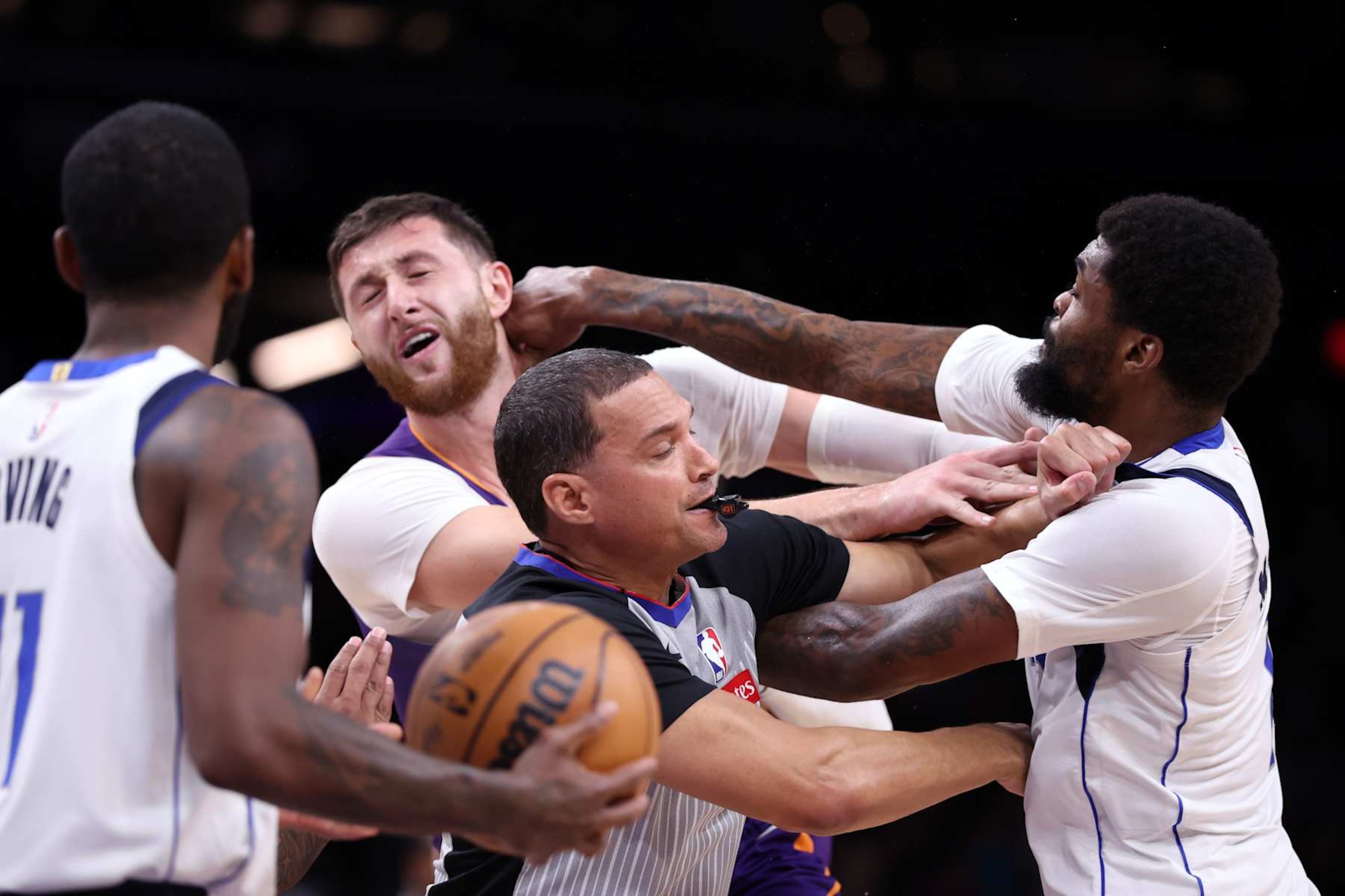 PHOENIX, ARIZONA - DECEMBER 27: Naji Marshall #13 of the Dallas Mavericks punches Jusuf Nurkic #20 of the Phoenix Suns during the second half at Footprint Center on December 27, 2024 in Phoenix, Arizona. NOTE TO USER: User expressly acknowledges and agrees that, by downloading and or using this photograph, User is consenting to the terms and conditions of the Getty Images License Agreement.  (Photo by Chris Coduto/Getty Images)