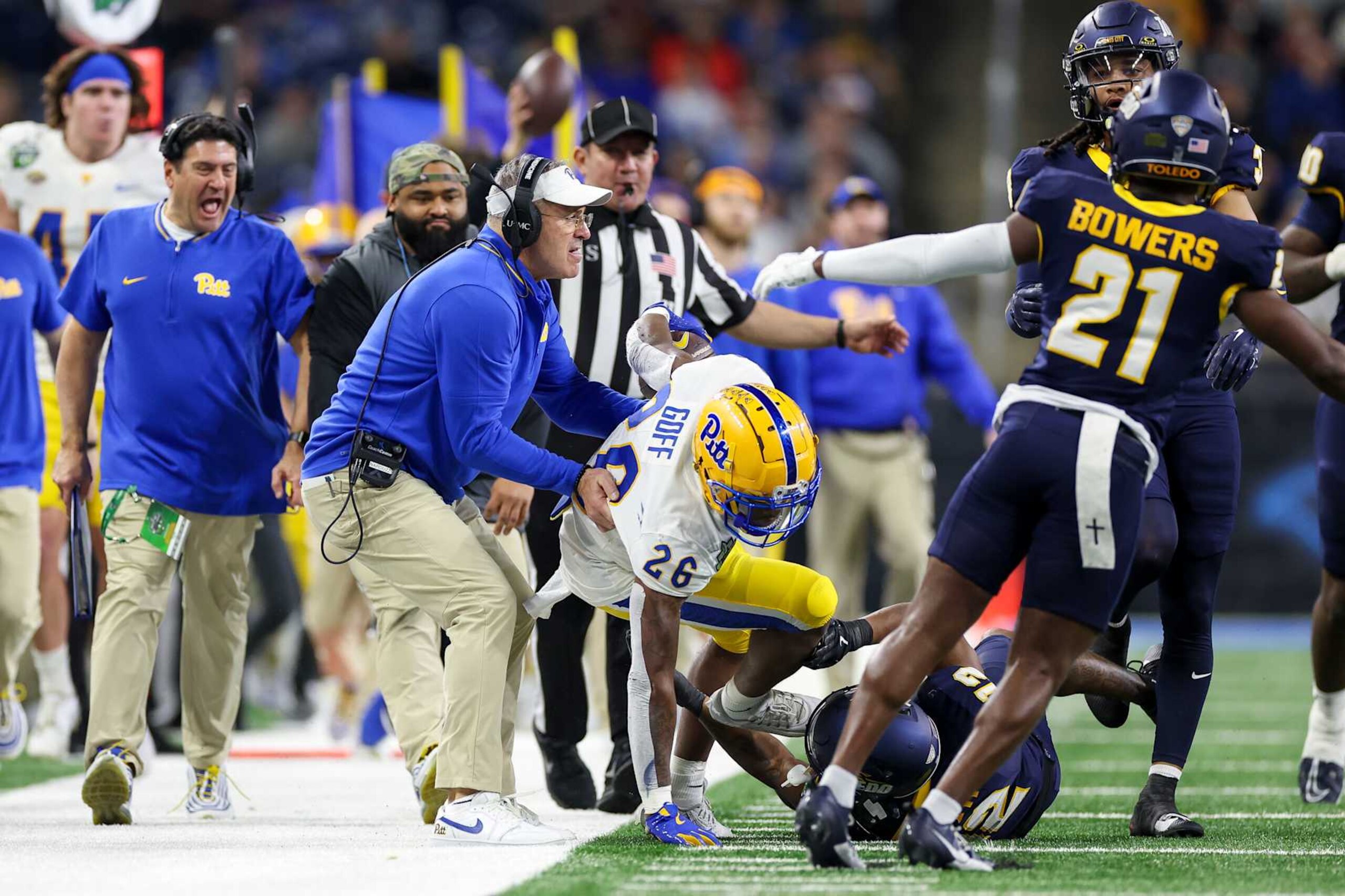 DETROIT, MICHIGAN - DECEMBER 26: Head coach Pat Narduzzi of the Pittsburgh Panthers picks Juelz Goff #26 up after he was tackled by Avery Smith #12 of the Toledo Rockets in the second quarter of the GameAbove Sports Bowl game at Ford Field on December 26, 2024 in Detroit, Michigan. (Photo by Mike Mulholland/Getty Images) DETROIT, MICHIGAN - DECEMBER 26: Head coach Pat Narduzzi of the Pittsburgh Panthers picks Juelz Goff #26 up after he was tackled by Avery Smith #12 of the Toledo Rockets in the second quarter of the GameAbove Sports Bowl game at Ford Field on December 26, 2024 in Detroit, Michigan. (Photo by Mike Mulholland/Getty Images)