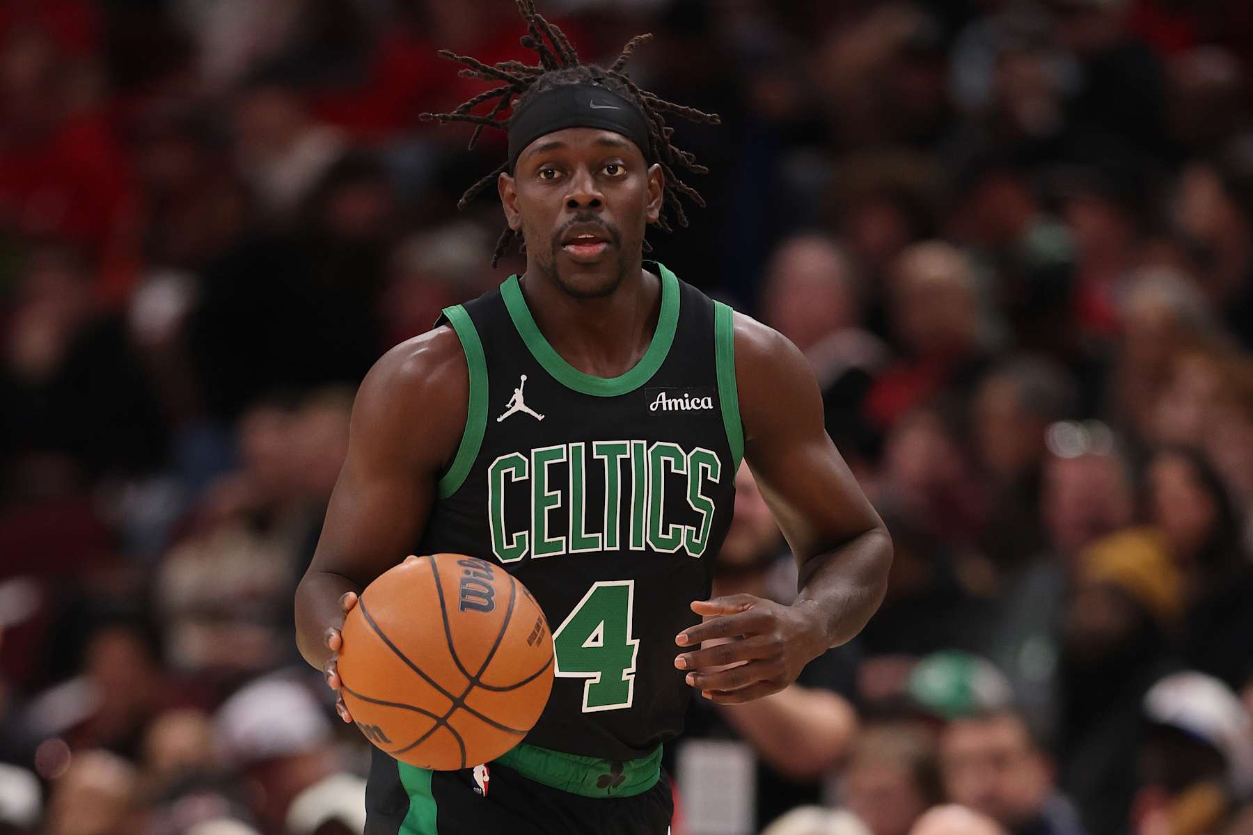 CHICAGO, ILLINOIS - DECEMBER 21: Jrue Holiday #4 of the Boston Celtics dribbles up the court against the Chicago Bulls during the first half at the United Center on December 21, 2024 in Chicago, Illinois. NOTE TO USER: User expressly acknowledges and agrees that, by downloading and or using this photograph, User is consenting to the terms and conditions of the Getty Images License Agreement.  (Photo by Michael Reaves/Getty Images)