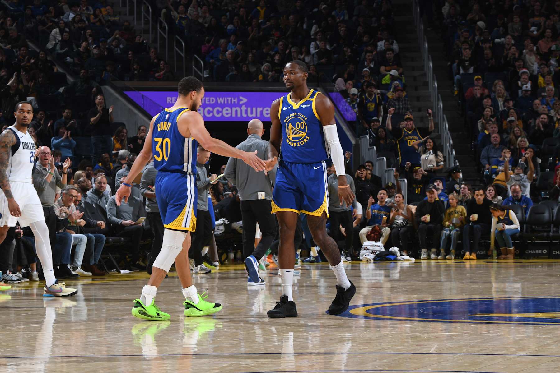 SAN FRANCISCO, CA - DECEMBER 15: Stephen Curry #30 and Jonathan Kuminga #00 of the Golden State Warriors high five during the game against the Dallas Mavericks on December 15, 2024 at Chase Center in San Francisco, California. NOTE TO USER: User expressly acknowledges and agrees that, by downloading and or using this photograph, user is consenting to the terms and conditions of Getty Images License Agreement. Mandatory Copyright Notice: Copyright 2024 NBAE (Photo by Noah Graham/NBAE via Getty Images)