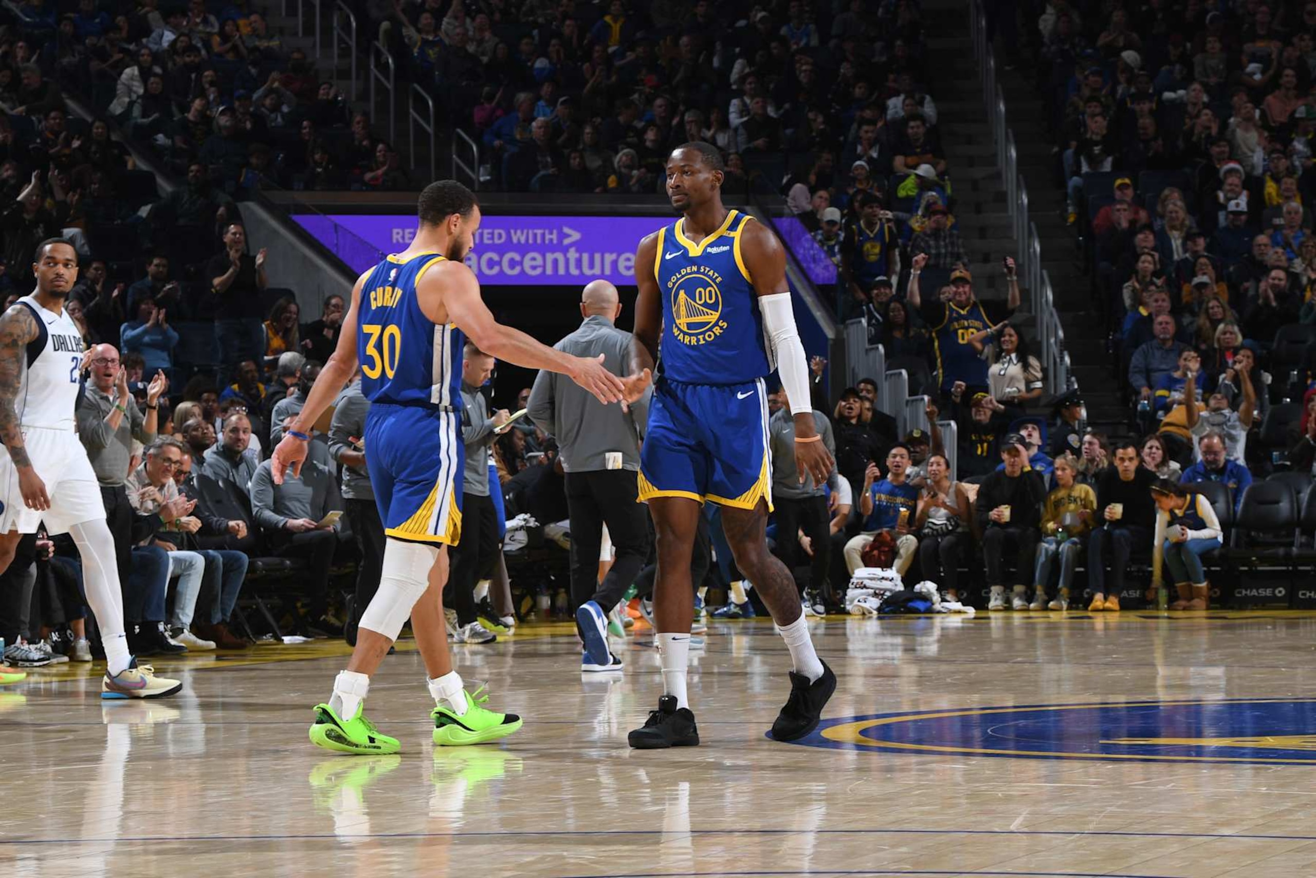 SAN FRANCISCO, CA - DECEMBER 15: Stephen Curry #30 and Jonathan Kuminga #00 of the Golden State Warriors high five during the game against the Dallas Mavericks on December 15, 2024 at Chase Center in San Francisco, California. NOTE TO USER: User expressly acknowledges and agrees that, by downloading and or using this photograph, user is consenting to the terms and conditions of Getty Images License Agreement. Mandatory Copyright Notice: Copyright 2024 NBAE (Photo by Noah Graham/NBAE via Getty Images)