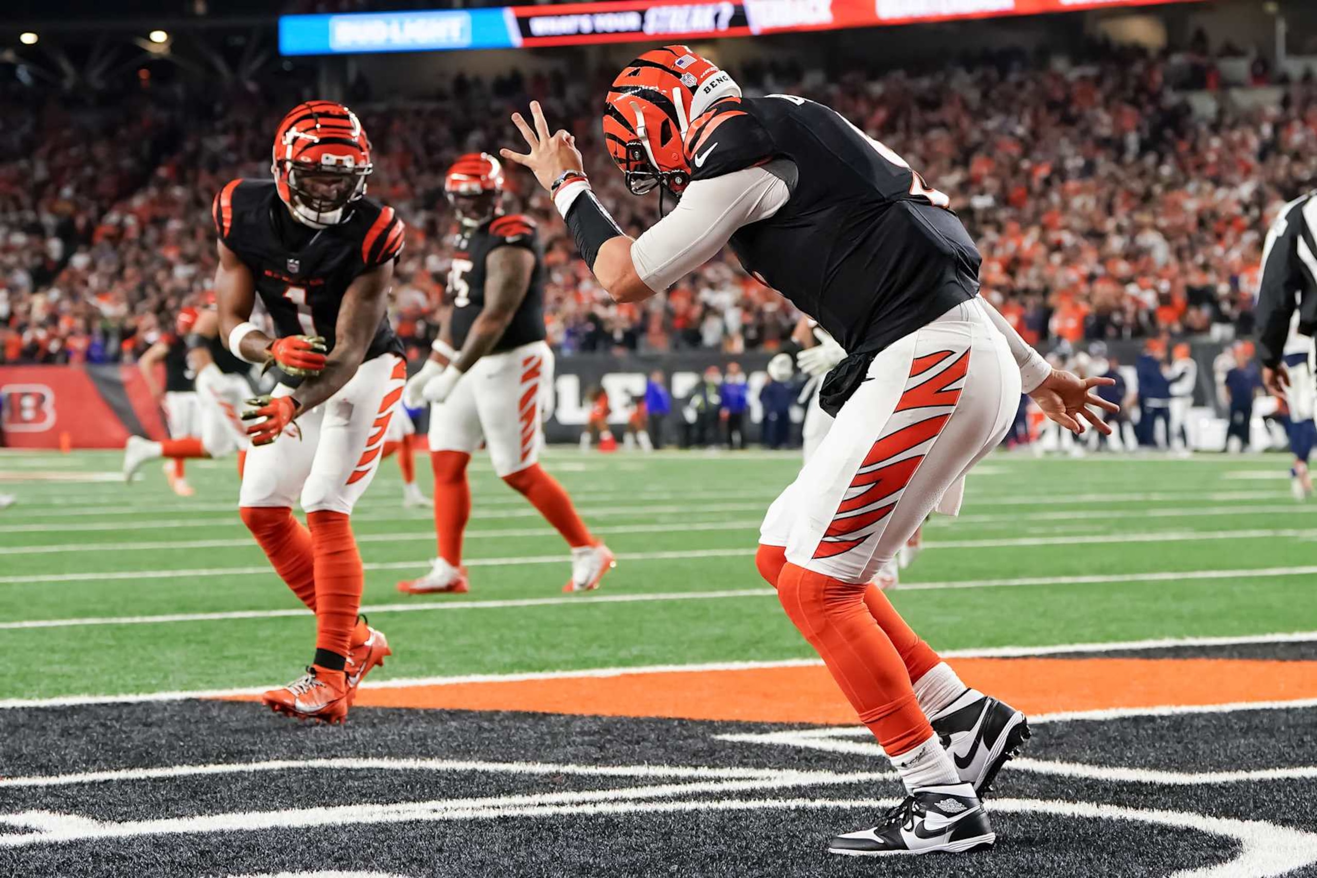 CINCINNATI, OHIO - DECEMBER 28: Ja'Marr Chase #1 and Joe Burrow #9 of the Cincinnati Bengals celebrate after Burrow scored a touchdown in the fourth quarter against the Denver Broncos at Paycor Stadium on December 28, 2024 in Cincinnati, Ohio. (Photo by Dylan Buell/Getty Images)