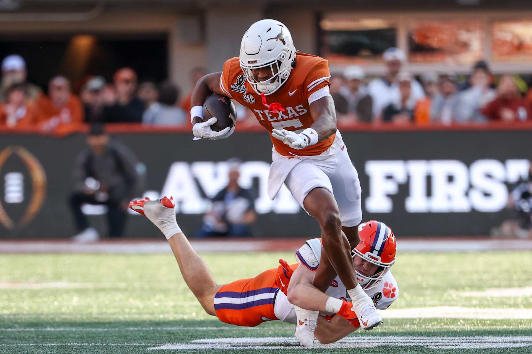 AUSTIN, TX - DECEMBER 21: Texas Longhorns wide receiver Ryan Wingo (5) breaks free from a tackle attempt by Clemson Tigers linebacker Wade Woodaz (17) during the CFP First Round game between Texas Longhorns and Clemson Tigers on December 21, 2024, at Darrell K Royal - Texas Memorial Stadium in Austin, TX. (Photo by David Buono/Icon Sportswire via Getty Images)